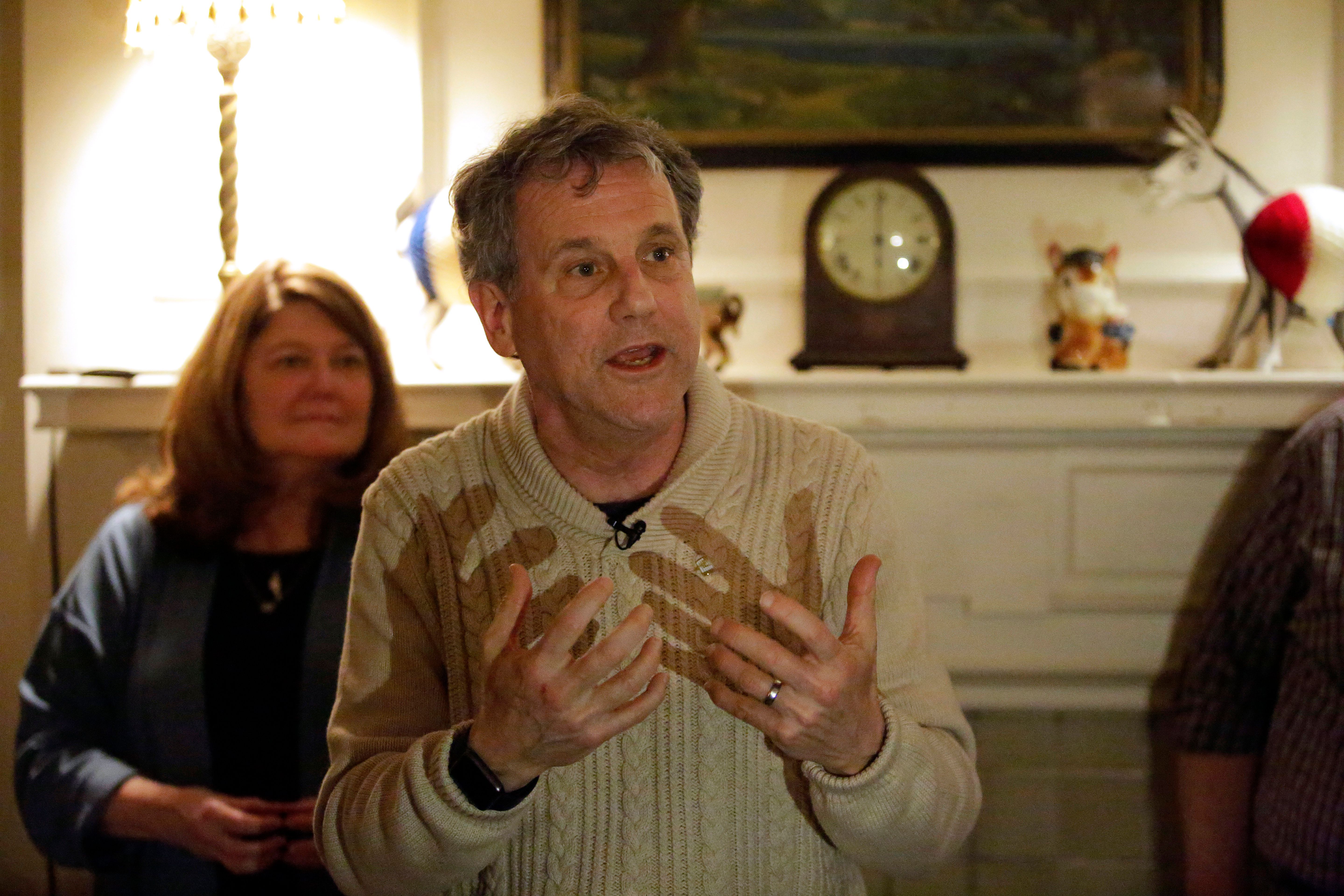 US Senator and possible 2020 presidential candidate Sherrod Brown (D-OH) speaks at a house party as his wife Connie Schultz (L) looks on during a campaign stop on February 1, 2019 in Waterloo, Iowa. (JOSHUA LOTT/AFP/Getty Images)