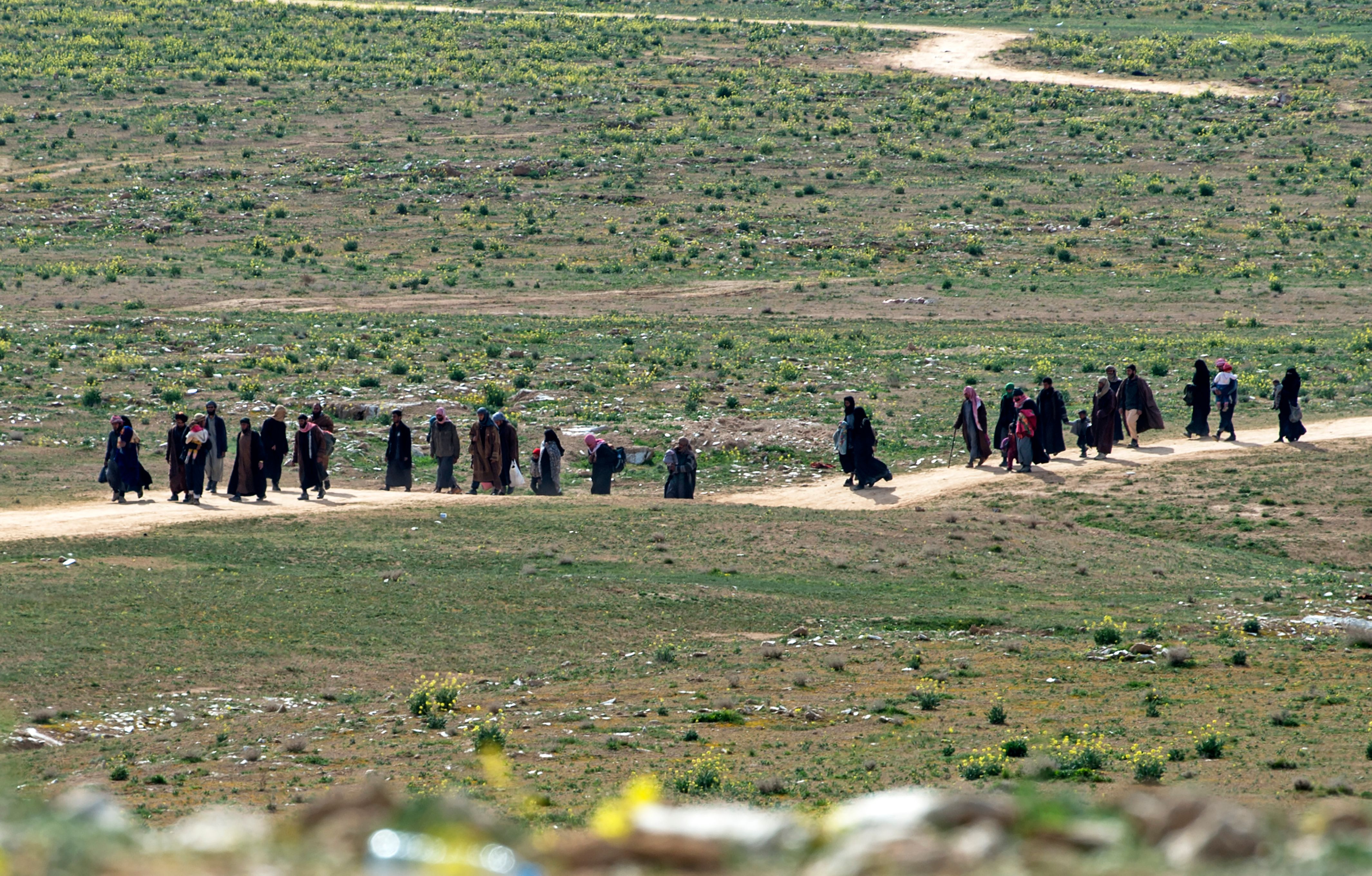 Men believed to be Islamic State fighters and their families leave the IS' embattled holdout of Baghouz on February 13, 2019
CREDIT: FADEL SENNA/AFP/Getty Images