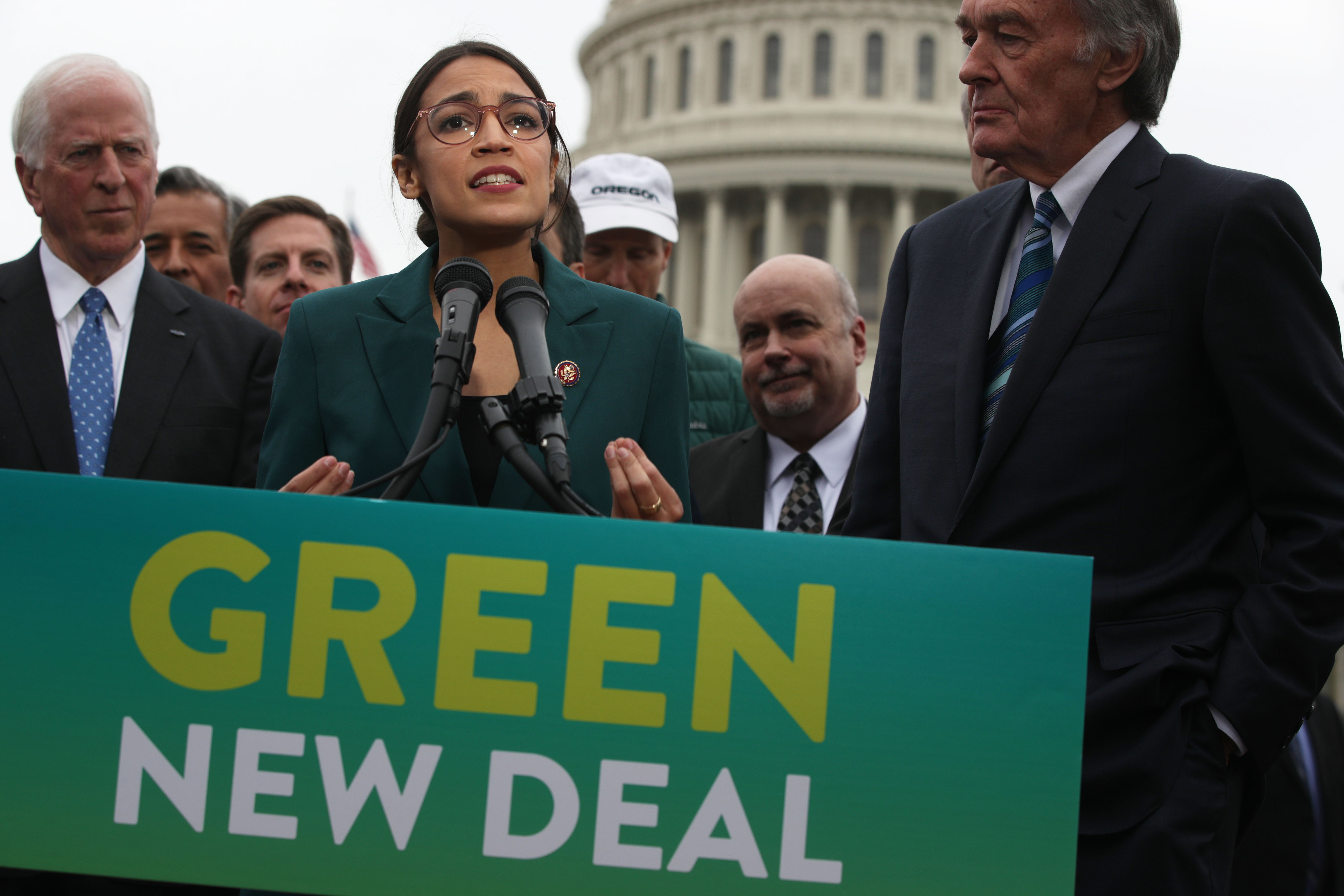 U.S. Rep. Alexandria Ocasio-Cortez (D-NY) speaks as Sen. Ed Markey (D-MA) (R) and other Congressional Democrats listen during a news conference in front of the U.S. Capitol February 7, 2019 in Washington, DC. CREDIT: Alex Wong/Getty Images