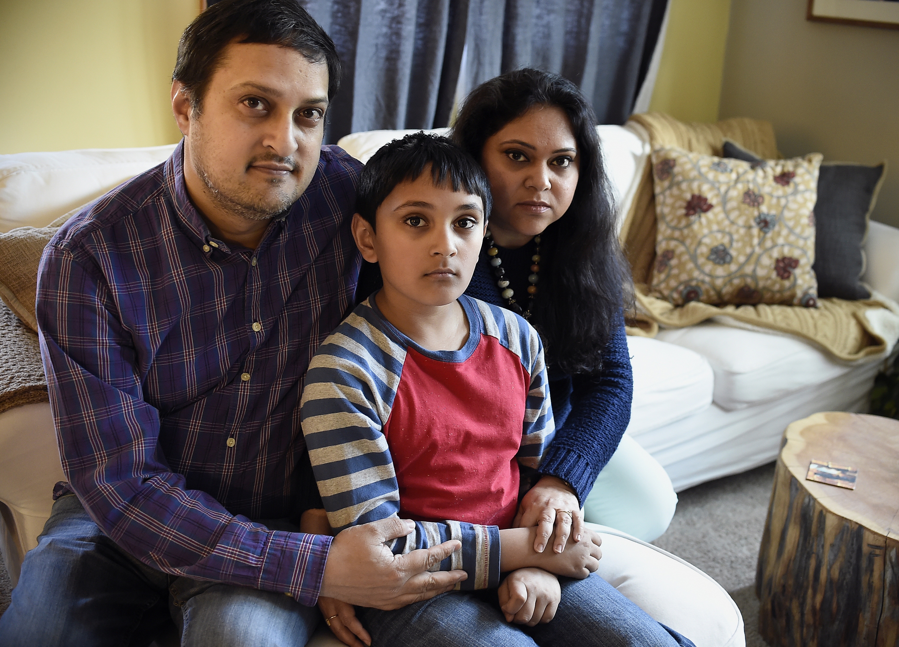 Sudarshana Sengupta, right, sits with her husband Sadhak, left, and son Josh, center, at their home in Sharon, Mass., Wednesday, April 5, 2017. (Photo Credit: Jessica Hill/For The Washington Post via Getty Images)