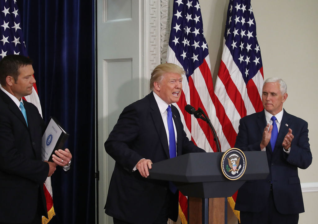 President Donald Trump, then-Kansas Secretary of State, Kris Kobach (R) Vice President Mike Pence during the first meeting of the Presidential Advisory Commission on Election Integrity in July 2017.