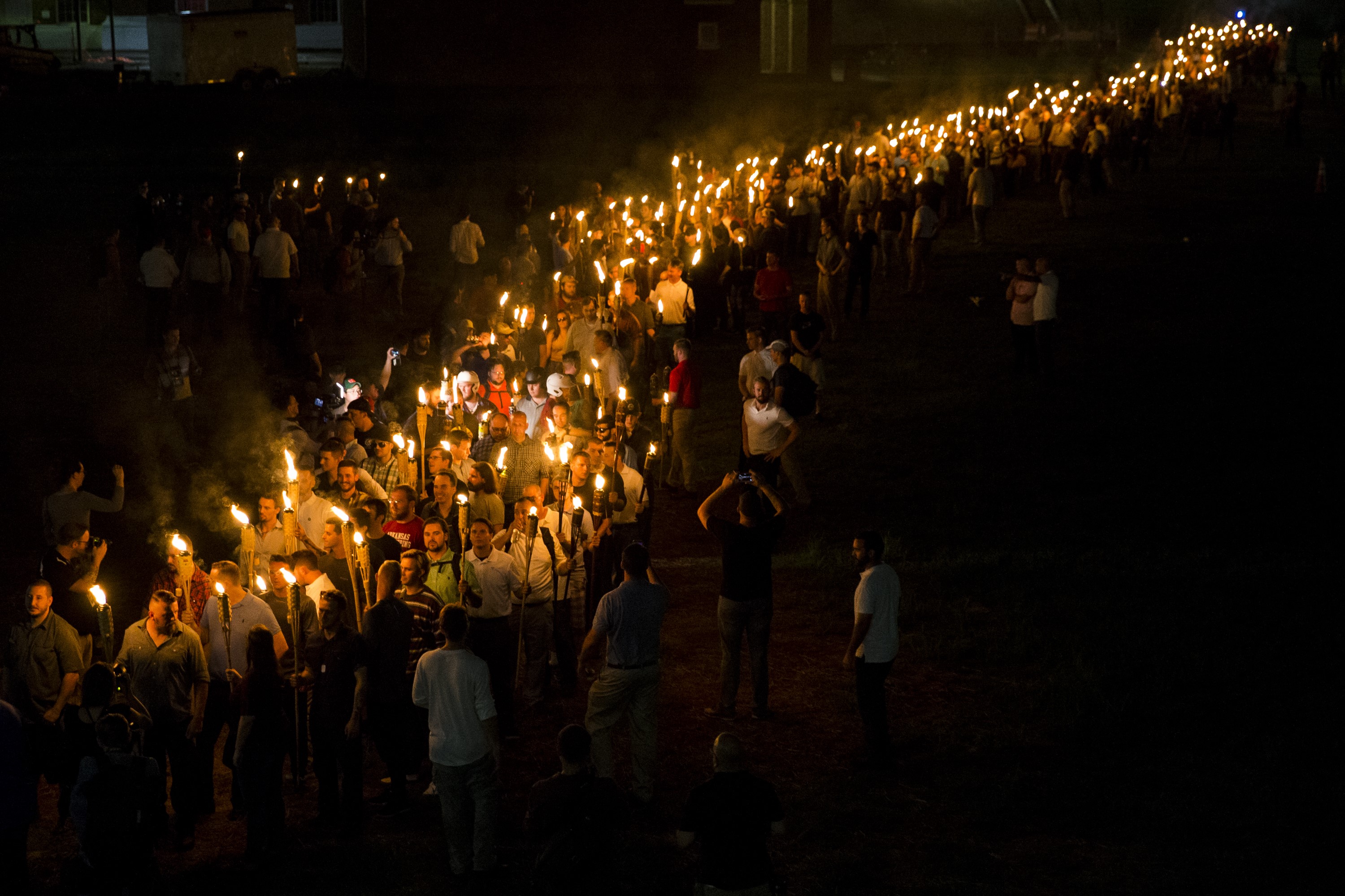 CHARLOTTESVILLE, USA - AUGUST 11: Neo Nazis, Alt-Right, and White Supremacists march through the University of Virginia Campus with torches in Charlottesville, Va., USA on August 11, 2017. (Photo by Samuel Corum/Anadolu Agency/Getty Images)