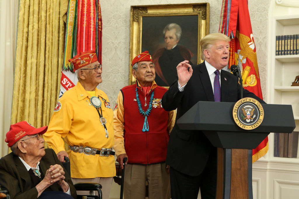 WASHINGTON, DC - NOVEMBER 27: (AFP OUT) U.S. President Donald Trump (R) speaks during an event honoring members of the Native American code talkers in the Oval Office of the White House, on November 27, 2017 in Washington, DC. Trump stated, "You were here long before any of us were here. Although we have a representative in Congress who they say was here a long time ago. They call her Pocahontas." in reference to his nickname for Sen. Elizabeth Warren. (Photo by Oliver Contreras-Pool/Getty Images)