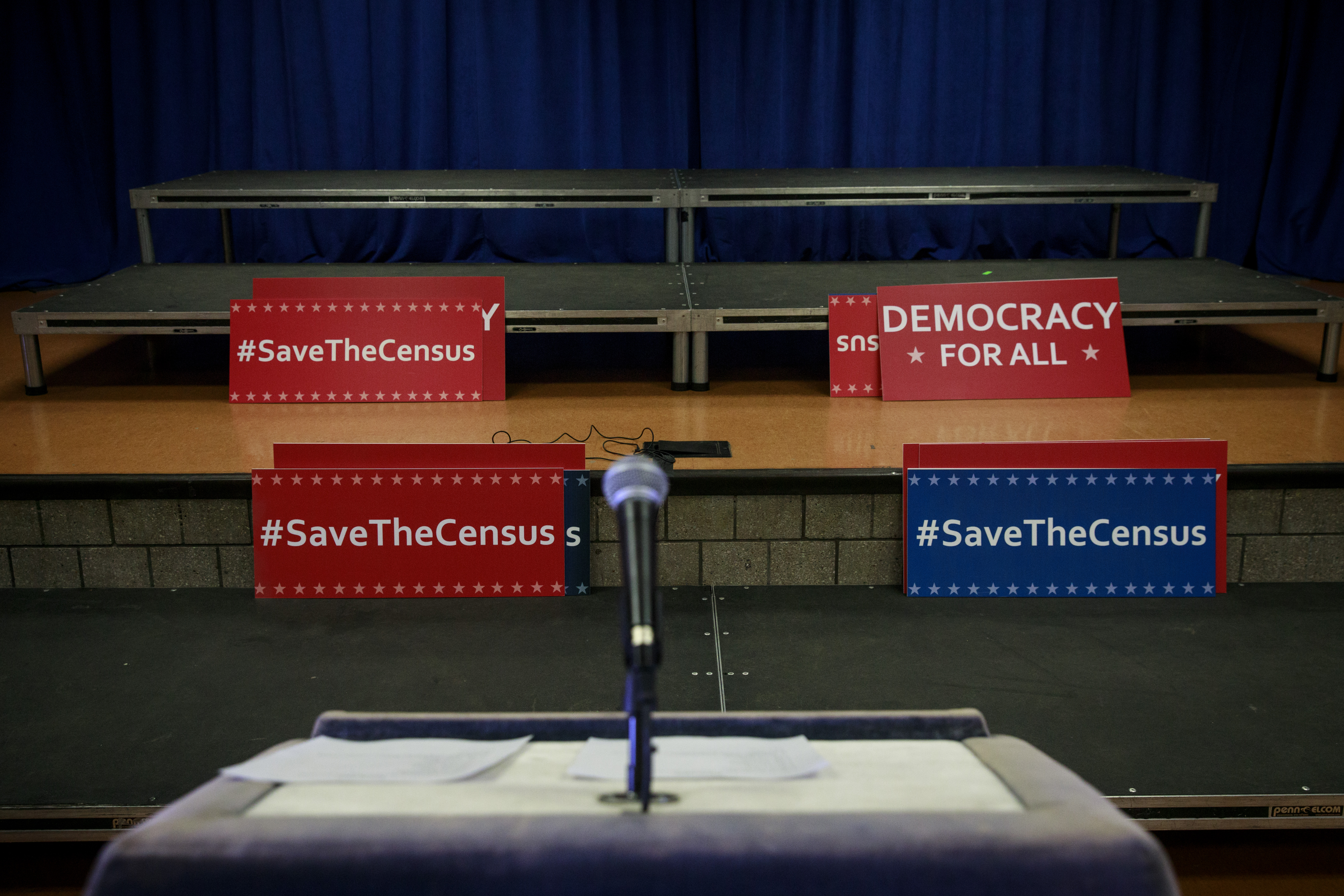 Signs sit behind the podium before the start of a press conference to announce a multi-state lawsuit to block the Trump administration from adding a question about citizenship to the 2020 Census form (Photo by Drew Angerer/Getty Images)