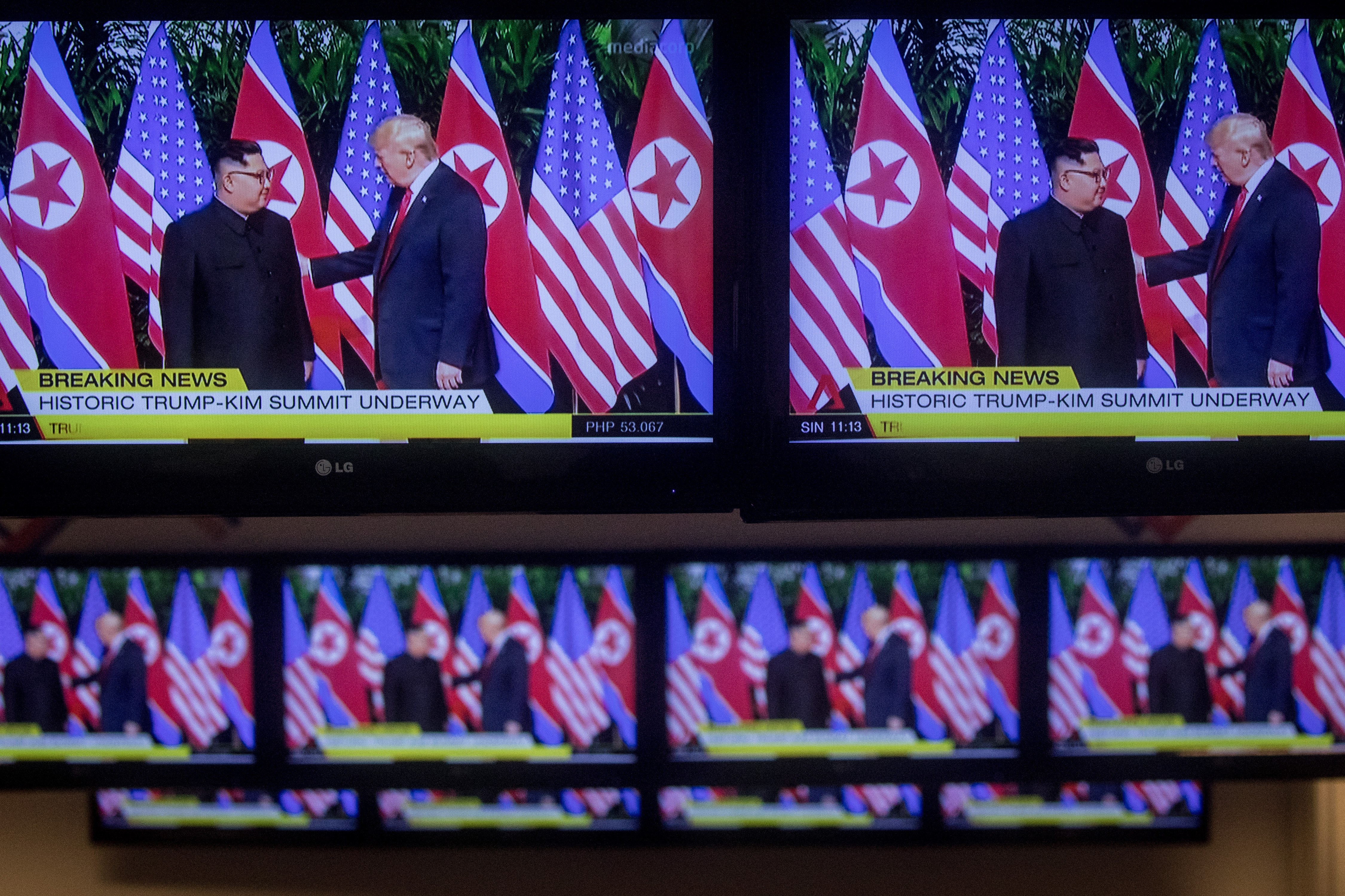 SINGAPORE - JUNE 12: Rows of tv screens at the international press center show footage of the meeting between U.S. President Donald Trump and North Korean leader Kim Jong-un on June 12, 2018 in Singapore. U.S. President Donald Trump and North Korean leader Kim Jong-un held the historic meeting on Tuesday morning in Singapore, carrying hopes of ending decades of hostility and the threat of North Korea's nuclear program. (Photo by Chris McGrath/Getty Images)