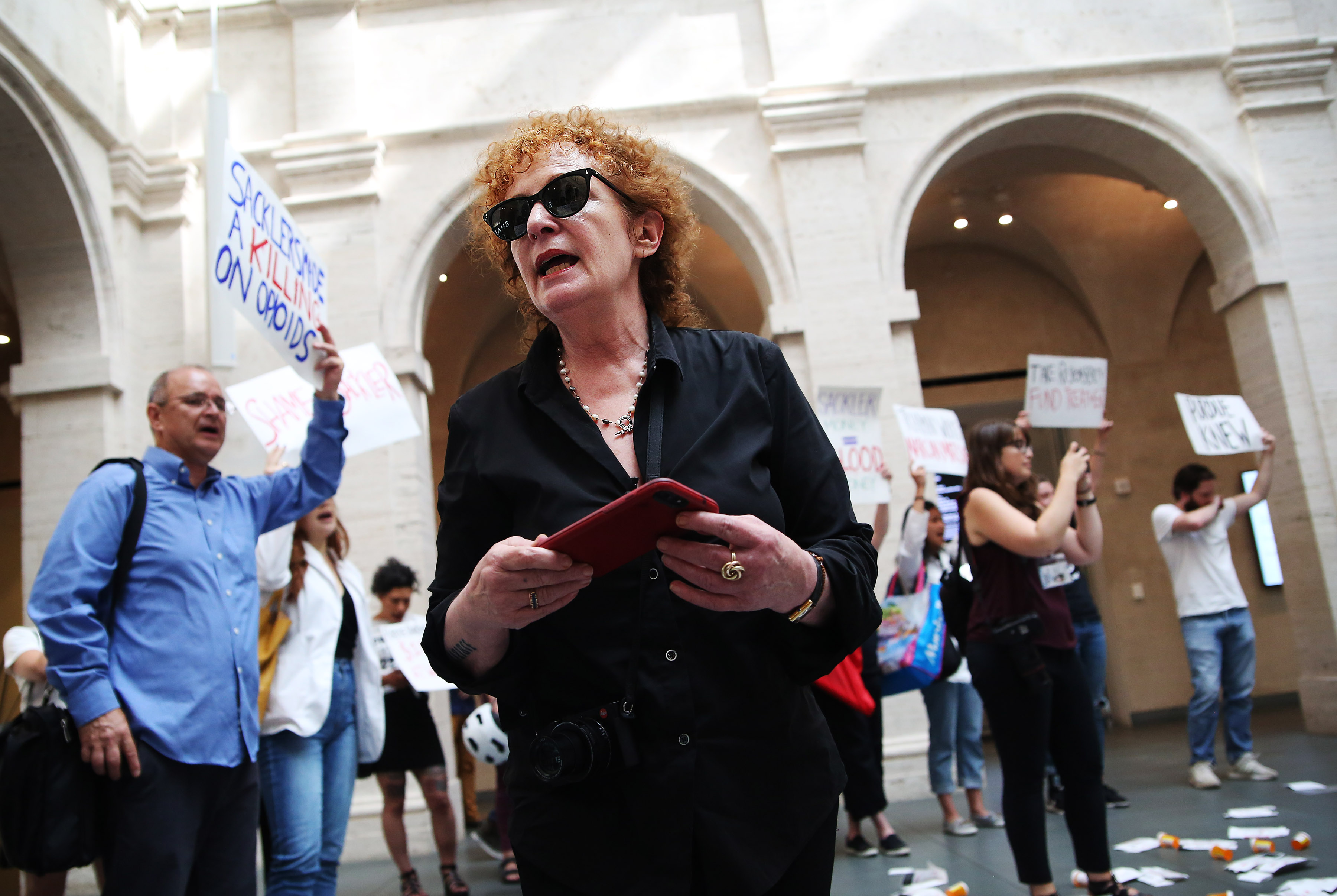 CAMBRIDGE, MA - JULY 20: Photographer Nan Goldin leads a demonstration at the Harvard Art Museums in Cambridge, MA on July 20, 2018 to protest the benefactor of the Sackler Art Museum, who was a founder of a pharmaceutical company that has made vast profits selling opioids. (Erin Clark for The Boston Globe via Getty Images)