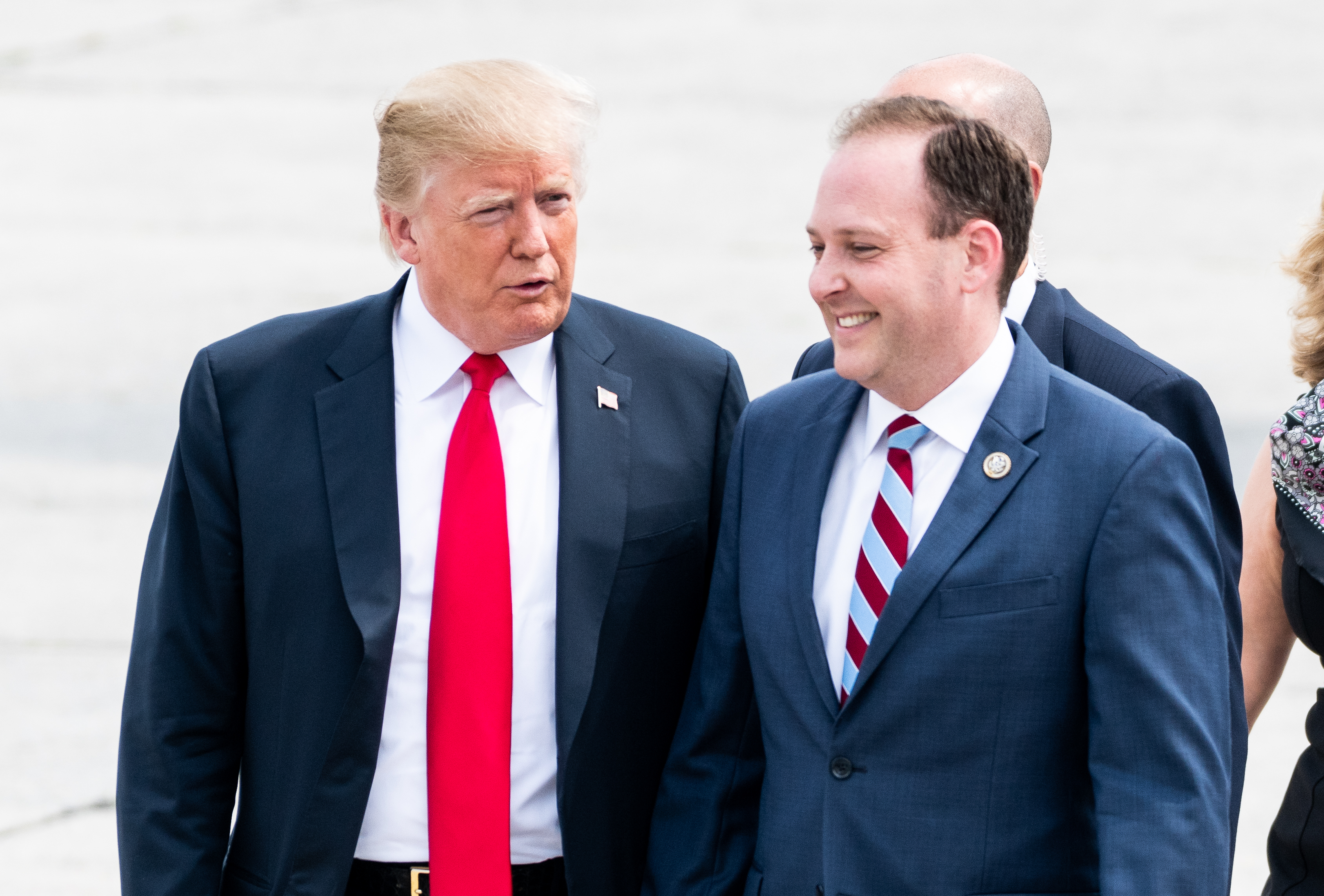 President Donald Trump speaking with Representative Lee Zeldin (R-NY) upon arrival in Westhampton, New York in August 2018. (Photo credit: Michael Brochstein/SOPA Images/LightRocket via Getty Images)