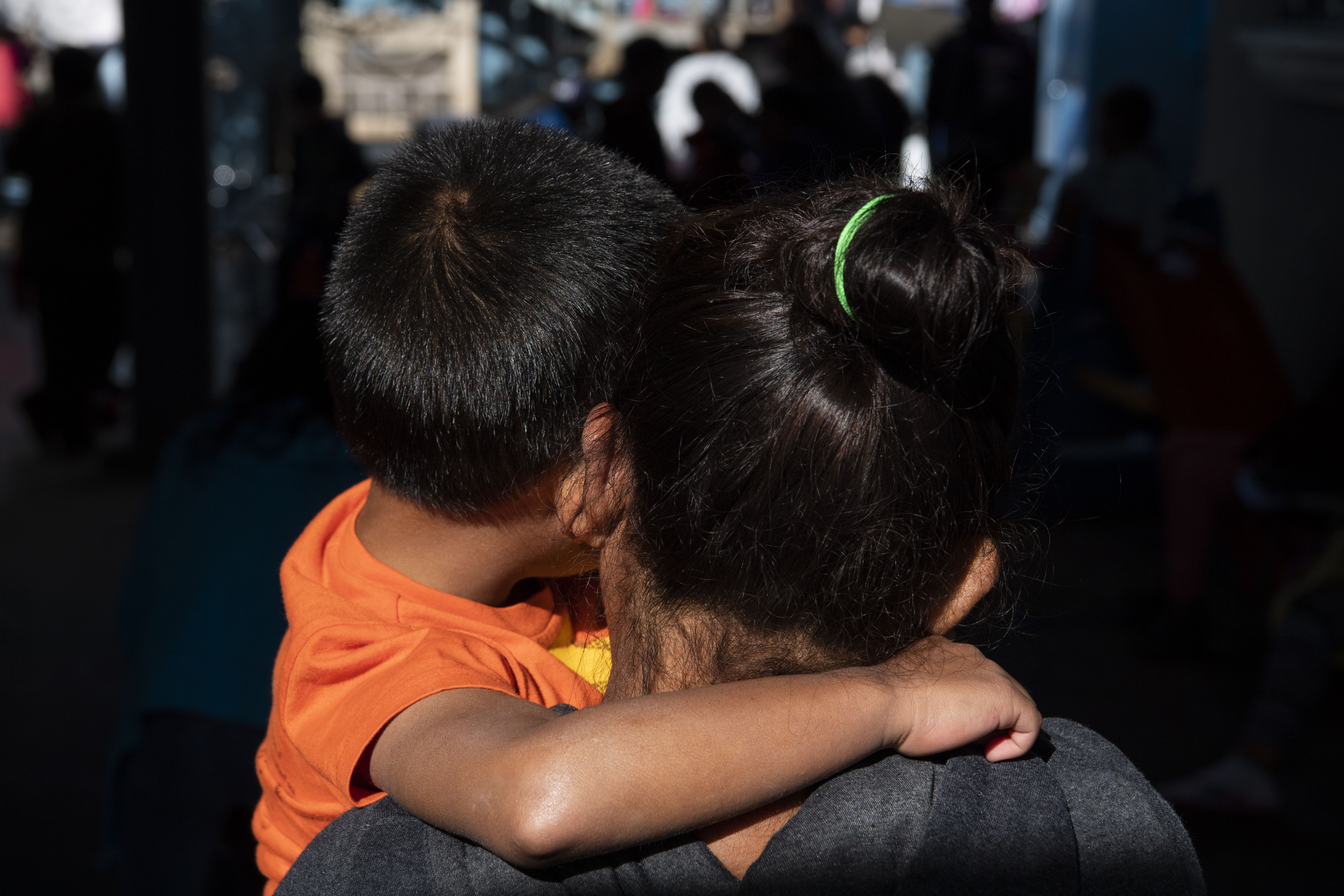 A mother and son from Guatemala, who asked not to show their faces or reveal their names for their safety, stand for a portrait at Instituto Madre Asunta shelter for migrants in Tijuana, Mexico on February 15, 2019. (Photo by Carolyn Van Houten/The Washington Post via Getty Images)