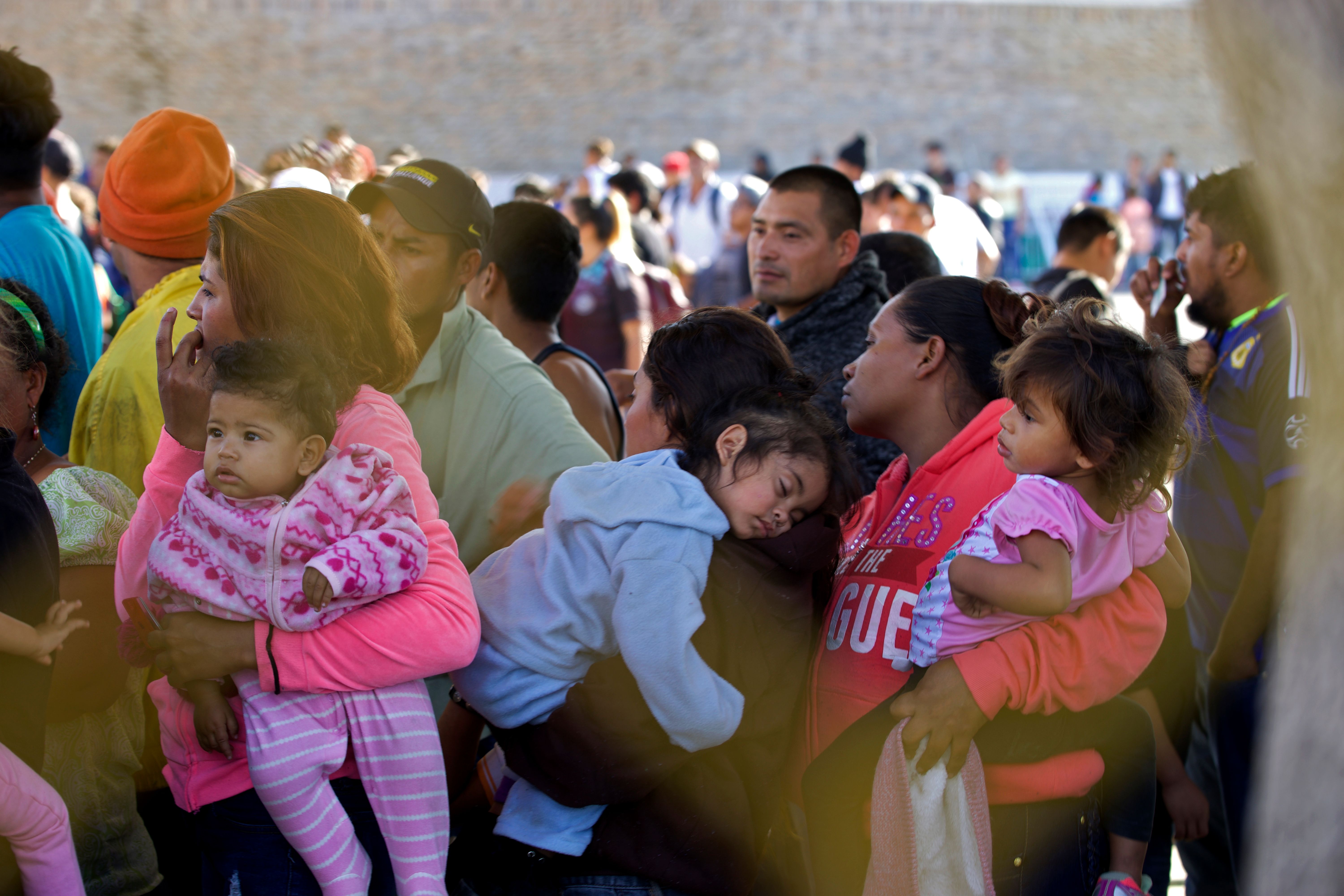 Central American migrants queue at a warehouse used as a shelter in Piedras Negras, Coahuila state, Mexico on February 16, 2019. (Credit: JULIO CESAR AGUILAR/AFP/Getty Images)