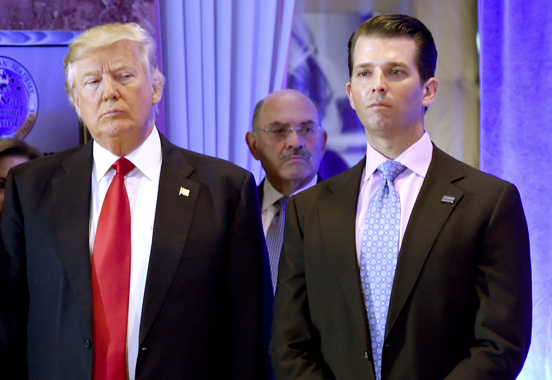 US President-elect Donald Trump along with his son Donald, Jr., arrive for a press conference at Trump Tower in New York, as Allen Weisselberg (C), chief financial officer of The Trump, looks on. - As US President Donald Trump's former lawyer Michael Cohen delivered hours of riveting testimony to a US House committee on February 27, 2019, one name came up again and again: Allen Weisselberg. Weisselberg, 71, is the publicity-shy chief financial officer of the Trump Organization and one of the real estate tycoon's oldest and closest advisors. (Photo by Timothy A. CLARY / AFP) (Photo credit should read TIMOTHY A. CLARY/AFP/Getty Images)
