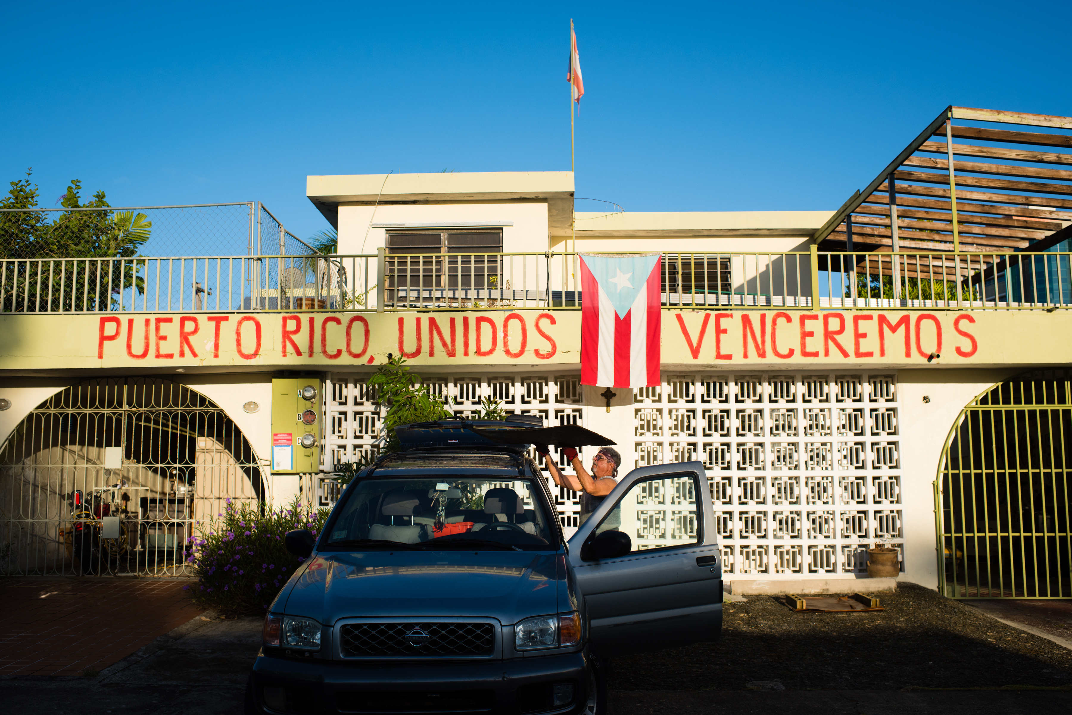Jaime Santana, 72, of Villa Nevarez in Rio Piedras, a neighborhood of San Juan, has painted the words, "Puerto Rico together we will overcome." CREDIT: Sarah L. Voisin/The Washington Post via Getty Images