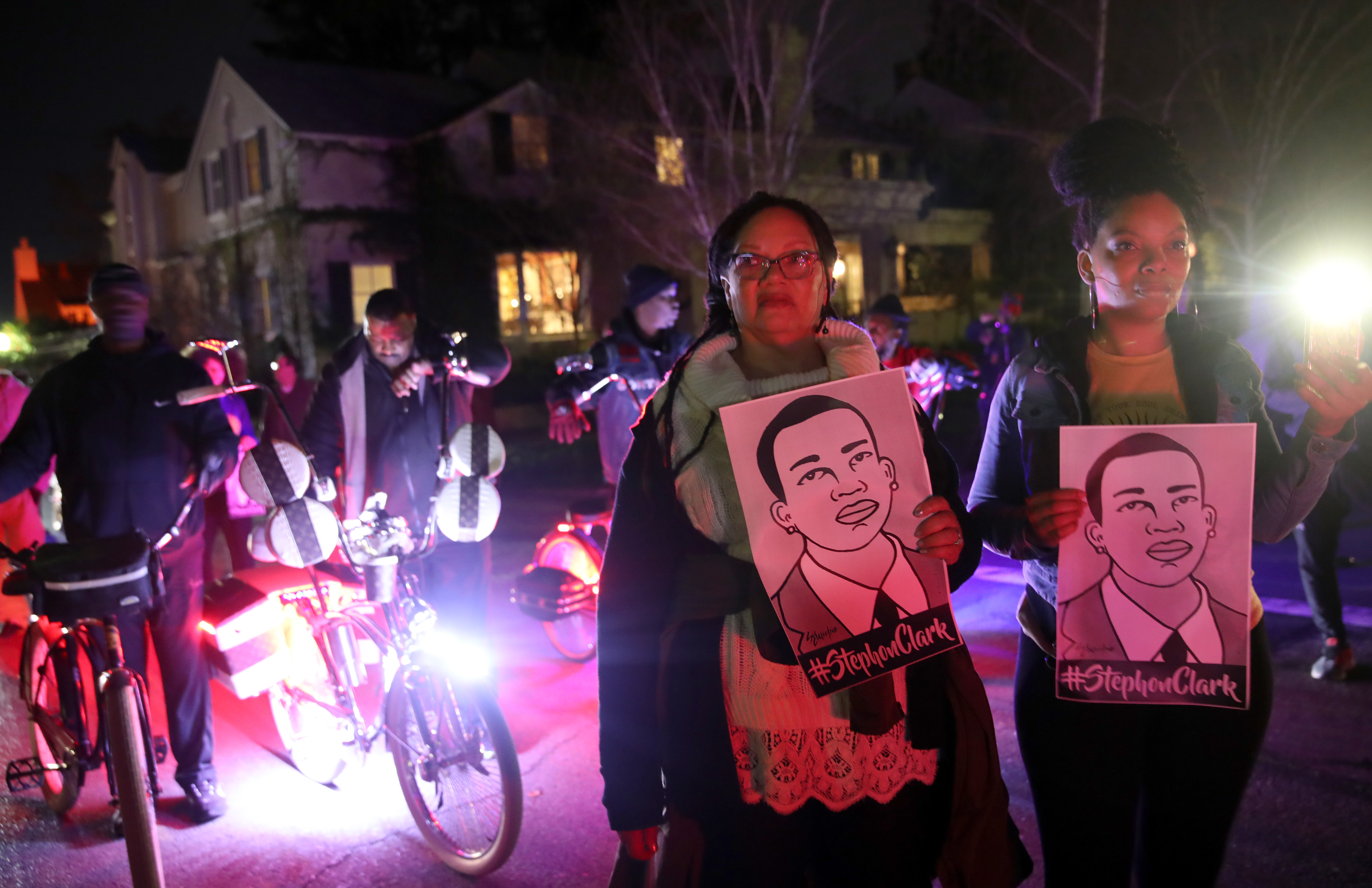 Protesters walk through the "Fab 40s" neighborhood of East Sacramento on Monday in response to the formal decision the the police officers who killed Stephon Clark in 2018 would not face criminal charges. CREDIT: Justin Sullivan/Getty Images