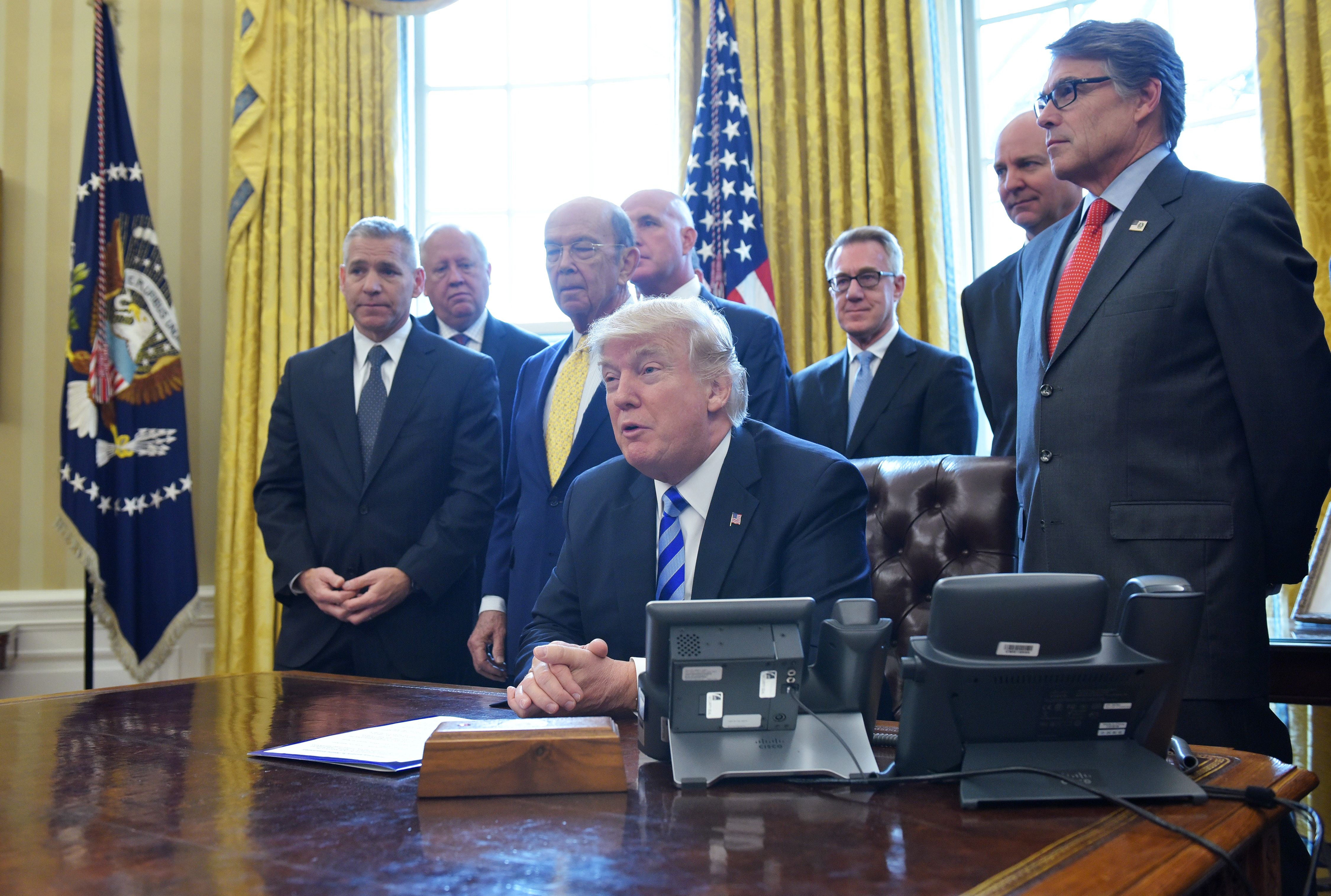 Trump approves Keystone XL in March 2017. CREDIT: MANDEL NGAN/AFP/Getty Images