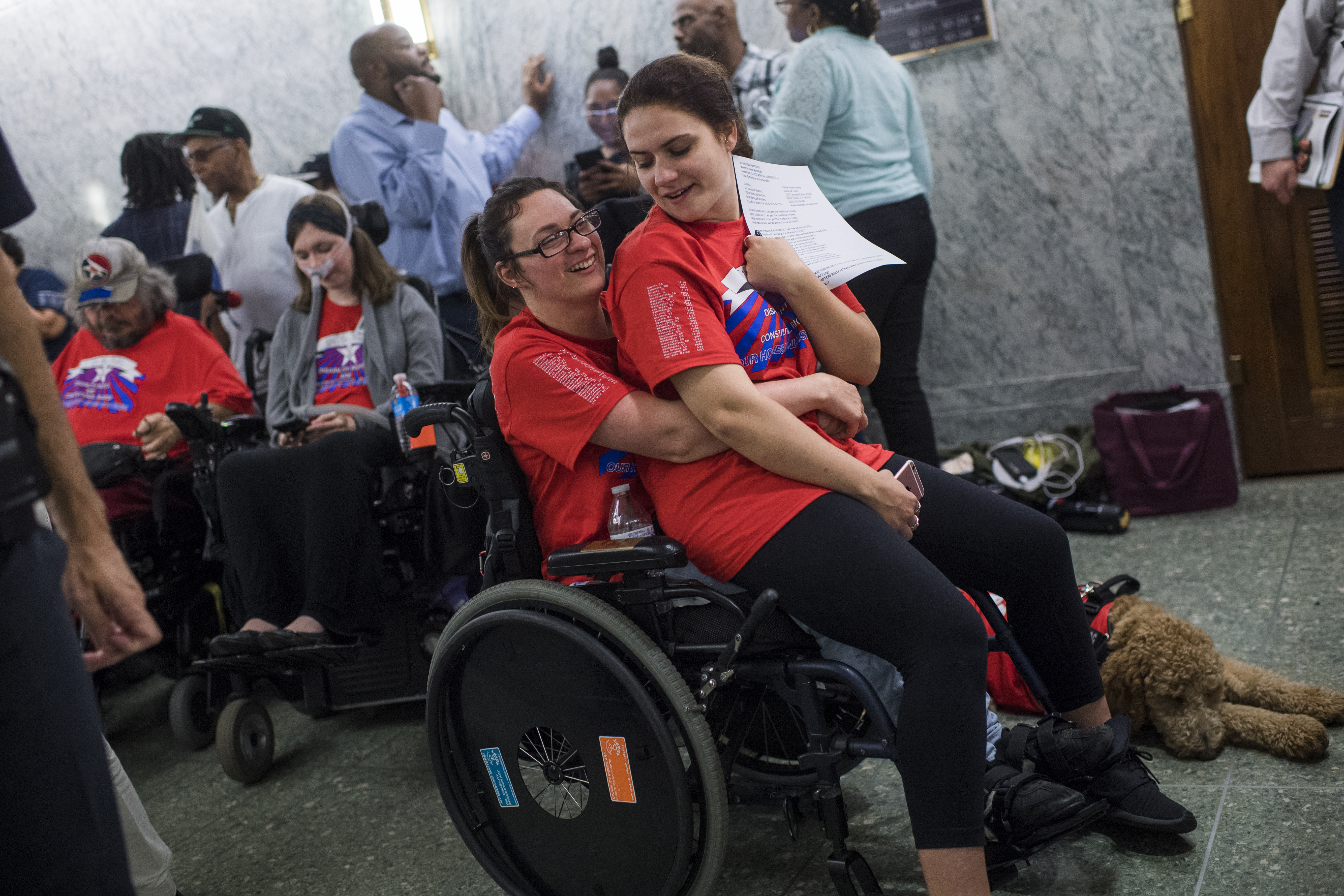 Shaylin Sluzalis, right, of Williamsport, Pa., and her sister Brittani, who has cerebral palsy, wait in line for a Senate Finance Committee hearing in Dirksen on the proposal by Sens. Lindsey Graham, R-S.C., and Bill Cassidy, R-La., which they oppose, to repeal and replace the Affordable Care Act on September 25, 2017. (Credit: Tom Williams/CQ Roll Call)
