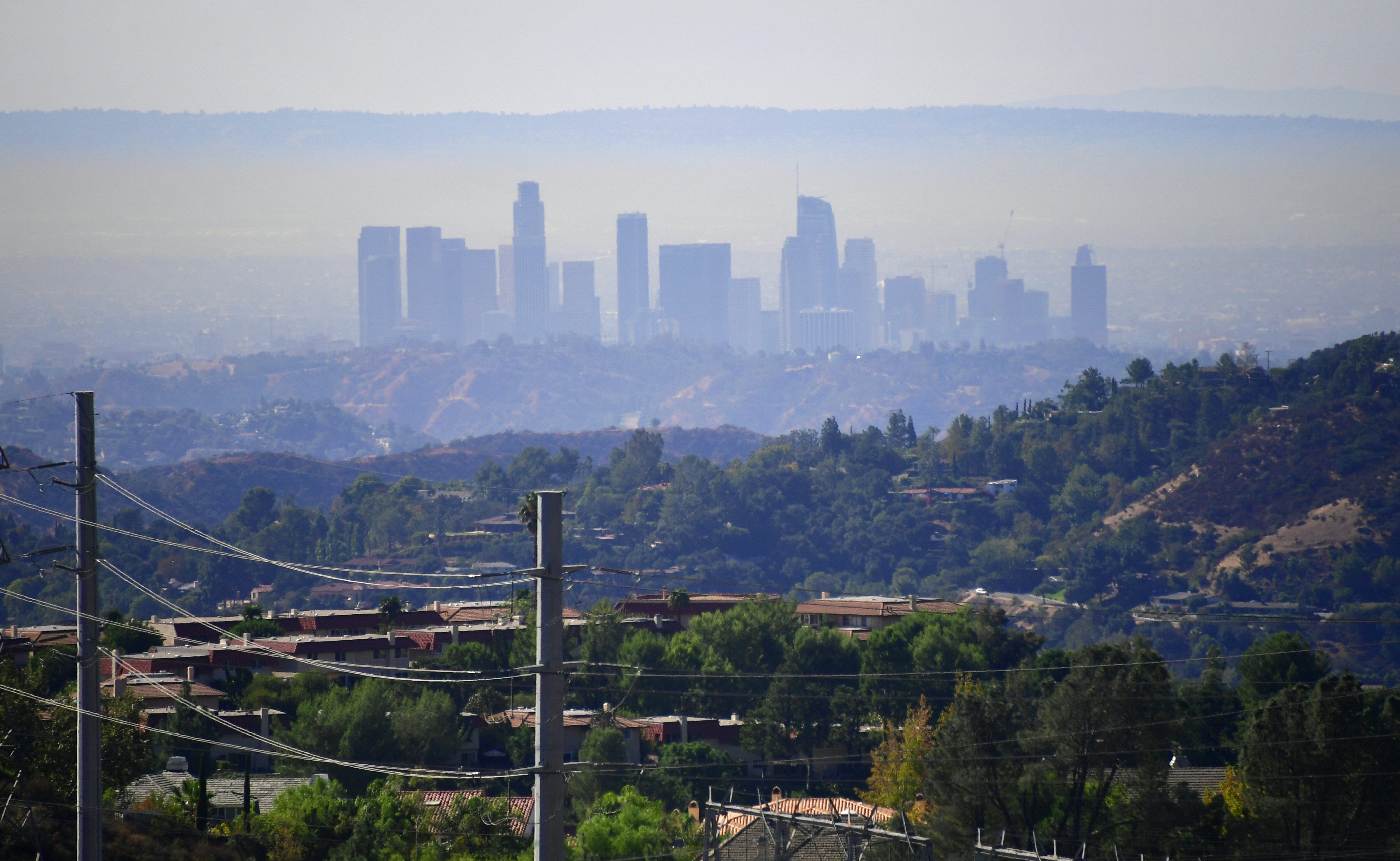 A layer of pollution can be seen hovering over Los Angeles, California on October 17, 2017, where even though air quality has improved in recent decades, smog levels remain among the nations's worst, with wildfires in the region also contributing to poor air quality. CREDIT: FREDERIC J. BROWN/AFP/Getty Images