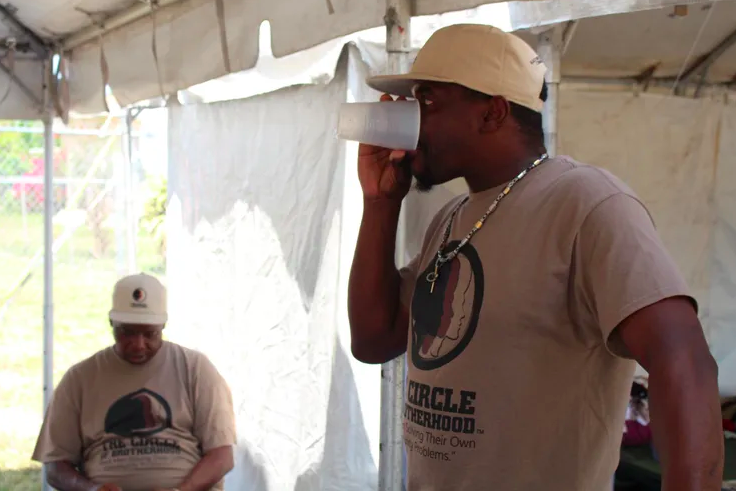 A Hunger Nine participant enjoying a sip of water. (Photo cred: Circle of Brotherhood)