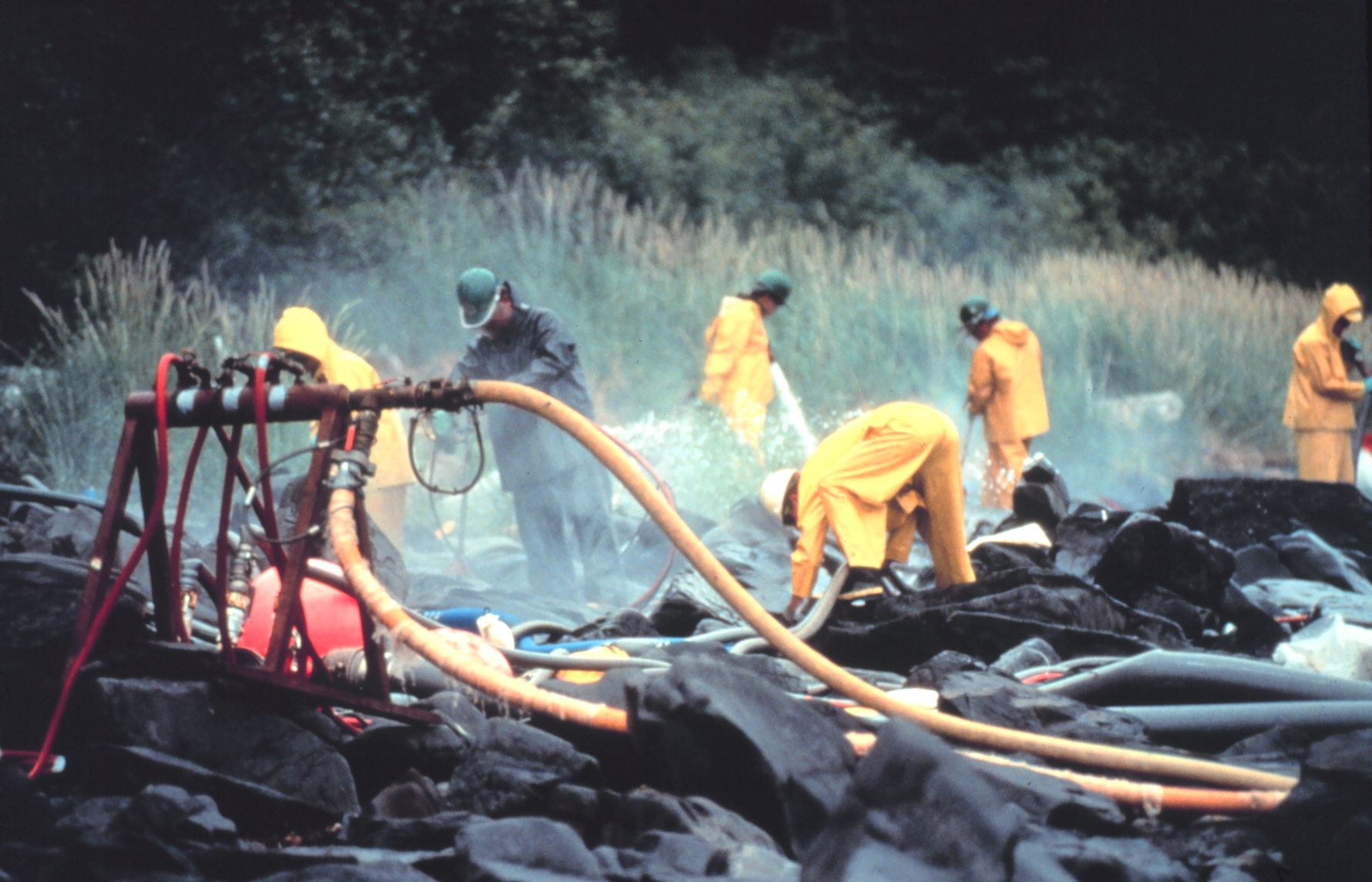 Pressure cleaning rocks in the aftermath of the spill near Prince William Sound, Alaska. CREDIT: NOAA