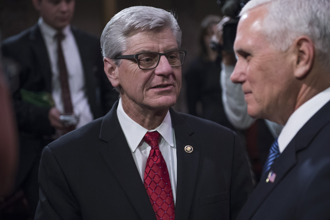 UNITED STATES - APRIL 9: Mississippi Gov. Phil Bryant, left, Vice President Mike Pence attend the swearing-in ceremony for Sen. Cindy Hyde-Smith, R-Miss., the Capitol's Old Senate Chamber after she was sworn in on the Senate floor on April 9, 2018.= (Photo By Tom Williams/CQ Roll Call)