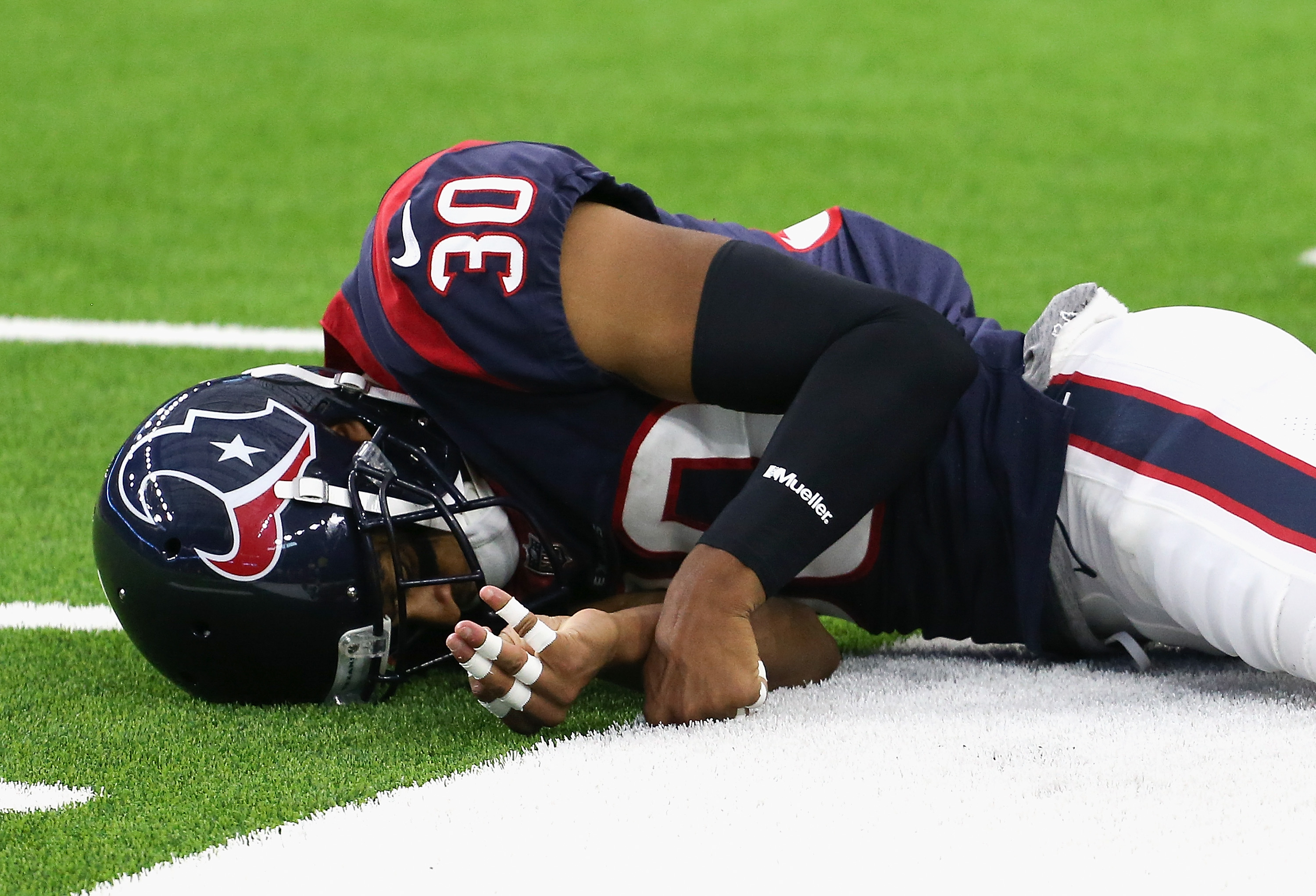 HOUSTON, TX - AUGUST 18: Kevin Johnson #30 of the Houston Texans lays on the field after hitting hard defending a pass in the first quarter during a preseason football game against the San Francisco 49ers at NRG Stadium on August 18, 2018 in Houston, Texas. Johnson would leave the game with a concussion. (Photo by Bob Levey/Getty Images)