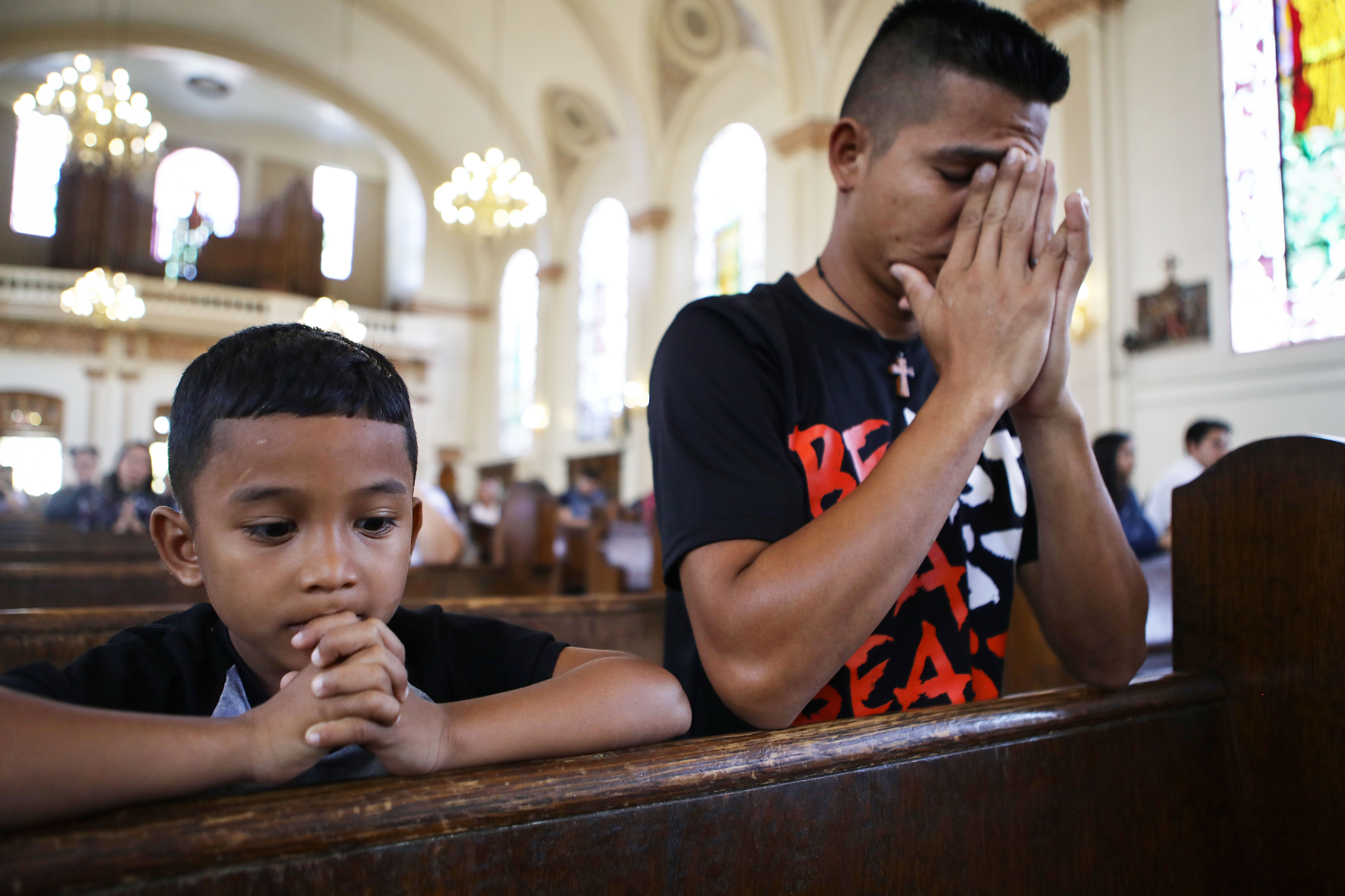 Honduran father Juan and his six-year-old son Anthony worship during Sunday Mass on September 9, 2018 in Oakland, California. They were separated for 85 days -- one of almost 2,600 families separated due to the Trump administration's "zero tolerance" immigration policy.(Photo by Mario Tama/Getty Images)