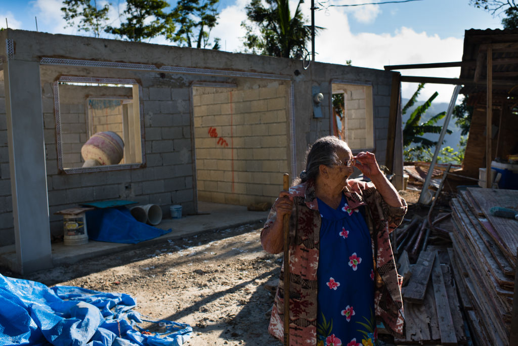Democrats overwhelmingly reject spending bill that underfunds Puerto Rico disaster relief. Pictured: After their home was completely destroyed by Hurricane Maria, Carlos Fernandez, 90, and his wife, Petra Gonzalez, 85, now live in a temporary wooden shack next to the construction of their home. (PHOTO CREDIT: Sarah L. Voisin/The Washington Post via Getty Images)