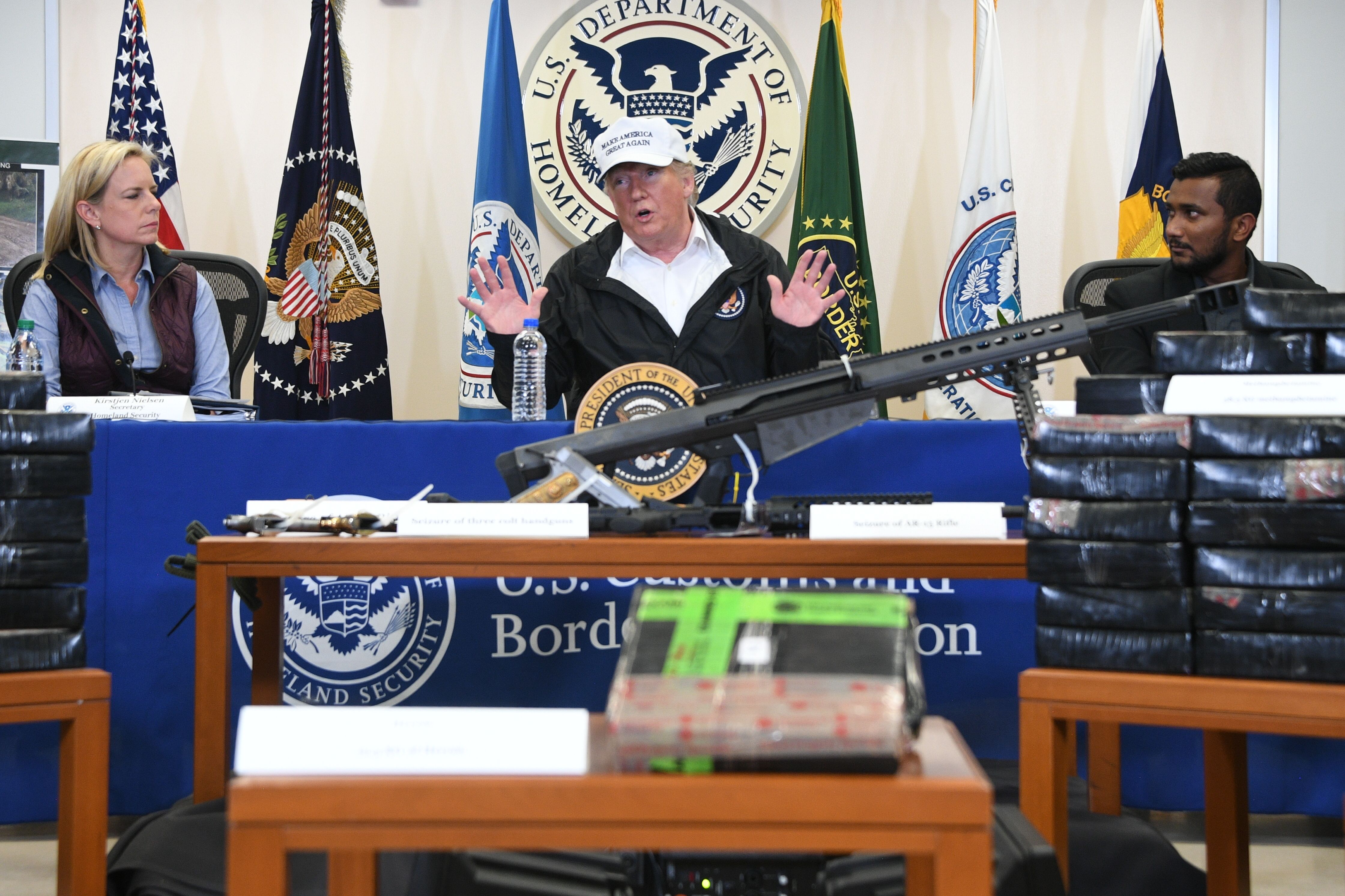 President Donald Trump, pictured here at a dope-on-the-table press conference with immigration officials in January, is seeking a fourfold increase in funding for a federal task force with dubious results. CREDIT: JIM WATSON/AFP/Getty Images