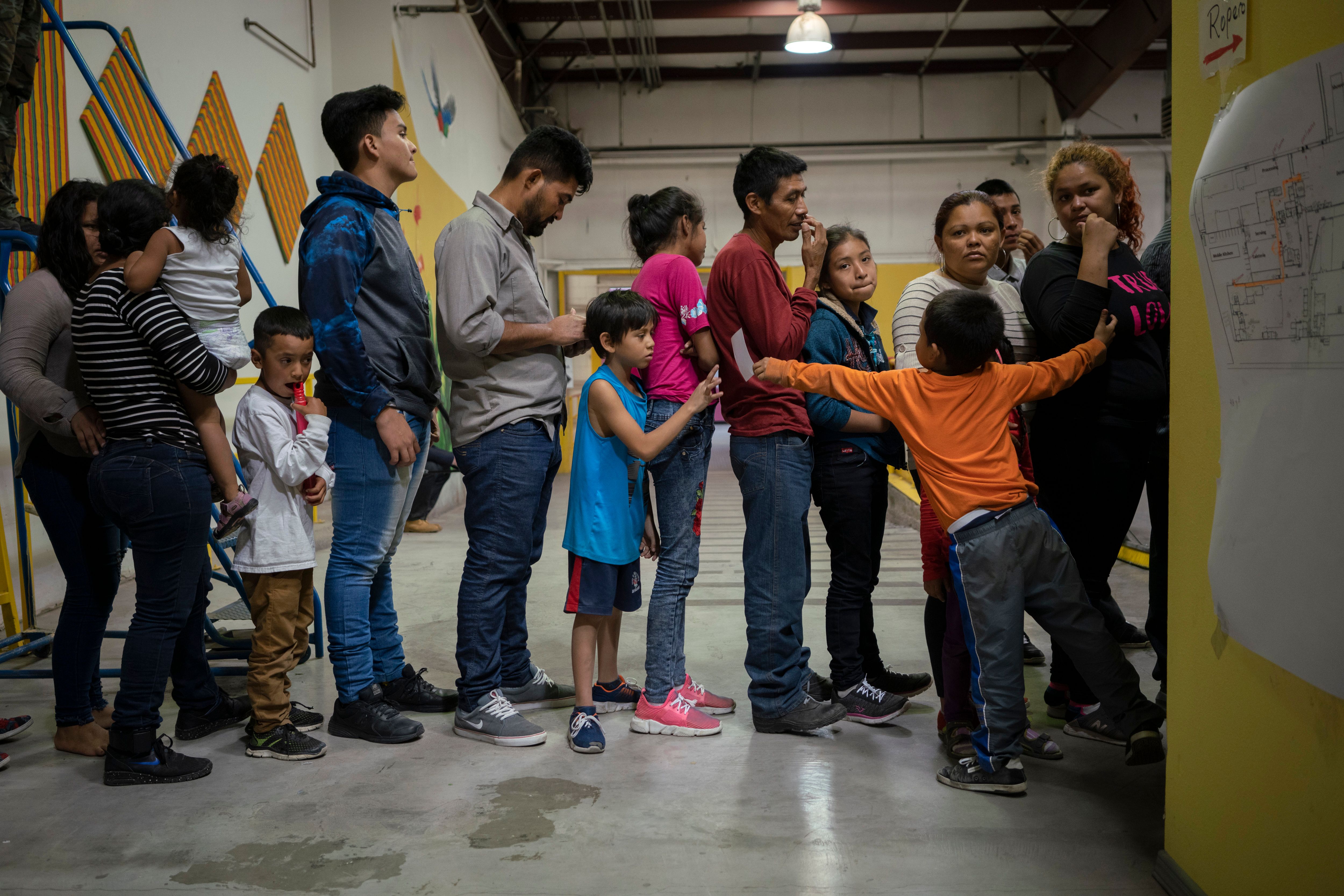Migrant children from different Latin American wait to receive food at the Casa del Refugiado, or The House of Refugee, a new centre opened by the Annunciation House to help the large flow of migrants being released by the United States Border Patrol and Immigration and Customs Enforcement in El Paso, Texas on April 24, 2019. (Photo credit: PAUL RATJE/AFP/Getty Images)