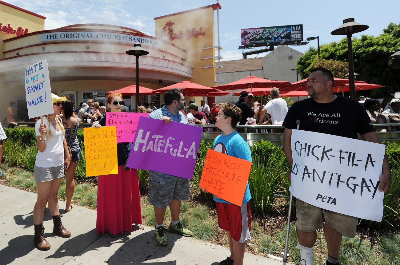Anti Chick-fil-A protestors hold signs at a 2012 protest in California