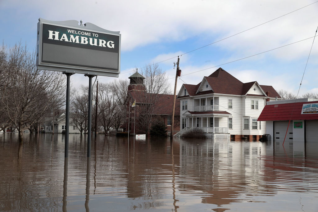 A home sits in flood water on March 20, 2019 in Hamburg, Iowa. Although flood water in the town has started to recede many homes and businesses remain surrounded by water. (Credit: Scott Olson/Getty Images)