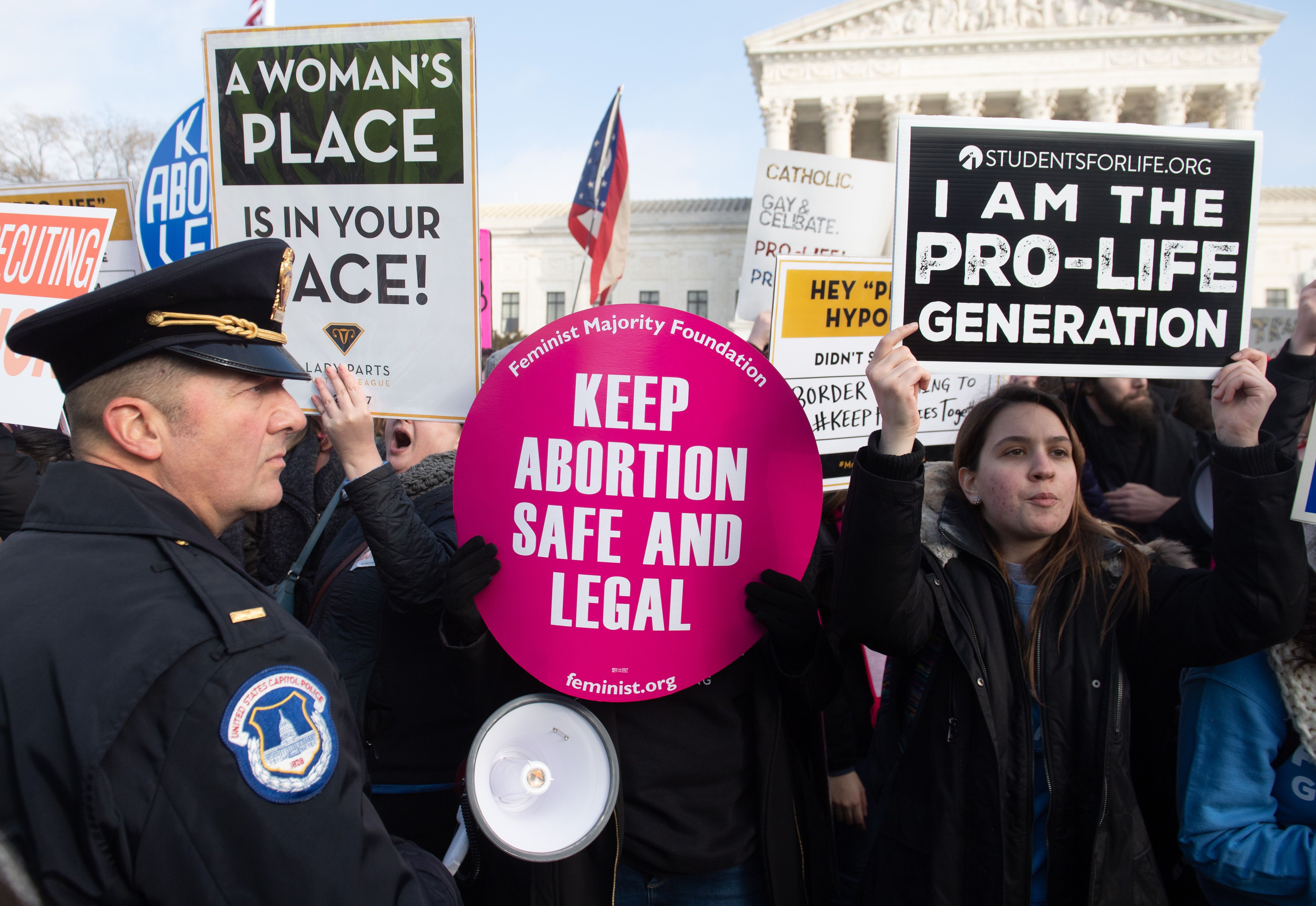 Pro-choice activists hold signs in response to anti-abortion activists participating in the "March for Life," an annual event to mark the anniversary of the 1973 Supreme Court case Roe v. Wade, which legalized abortion in the US, outside the US Supreme Court in Washington, DC, January 18, 2019. (Photo by SAUL LOEB / AFP) (Photo credit should read SAUL LOEB/AFP/Getty Images)