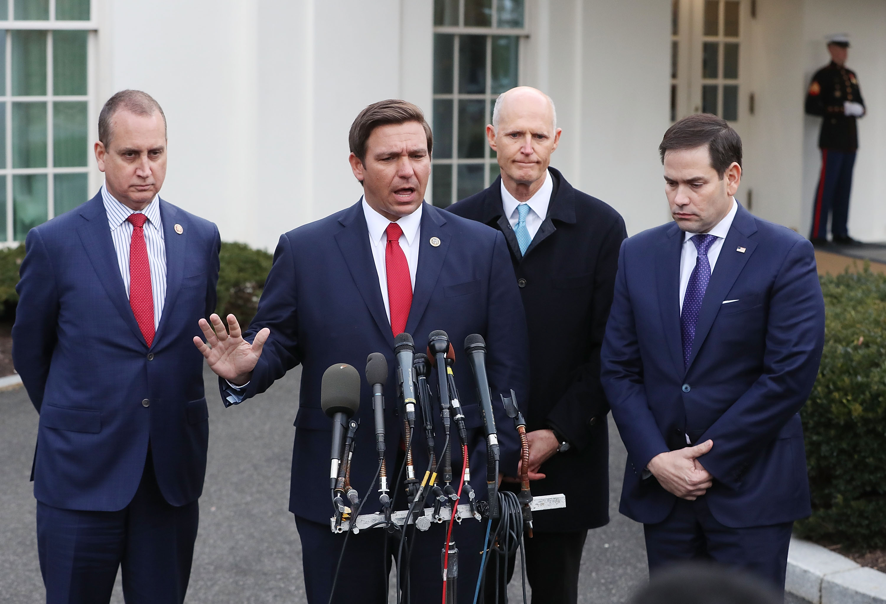 Florida Governor Ron DeSantis speaks to the media while flanked by (L-R) Rep. Mario Diaz-Balart (R-FL), Sen. Rick Scott (R-FL) and Sen. Marco Rubio (R-FL), after a meeting with President Donald Trump regarding Venezuela on January 22, 2019 in Washington, DC. CREDIT: Mark Wilson/Getty Images