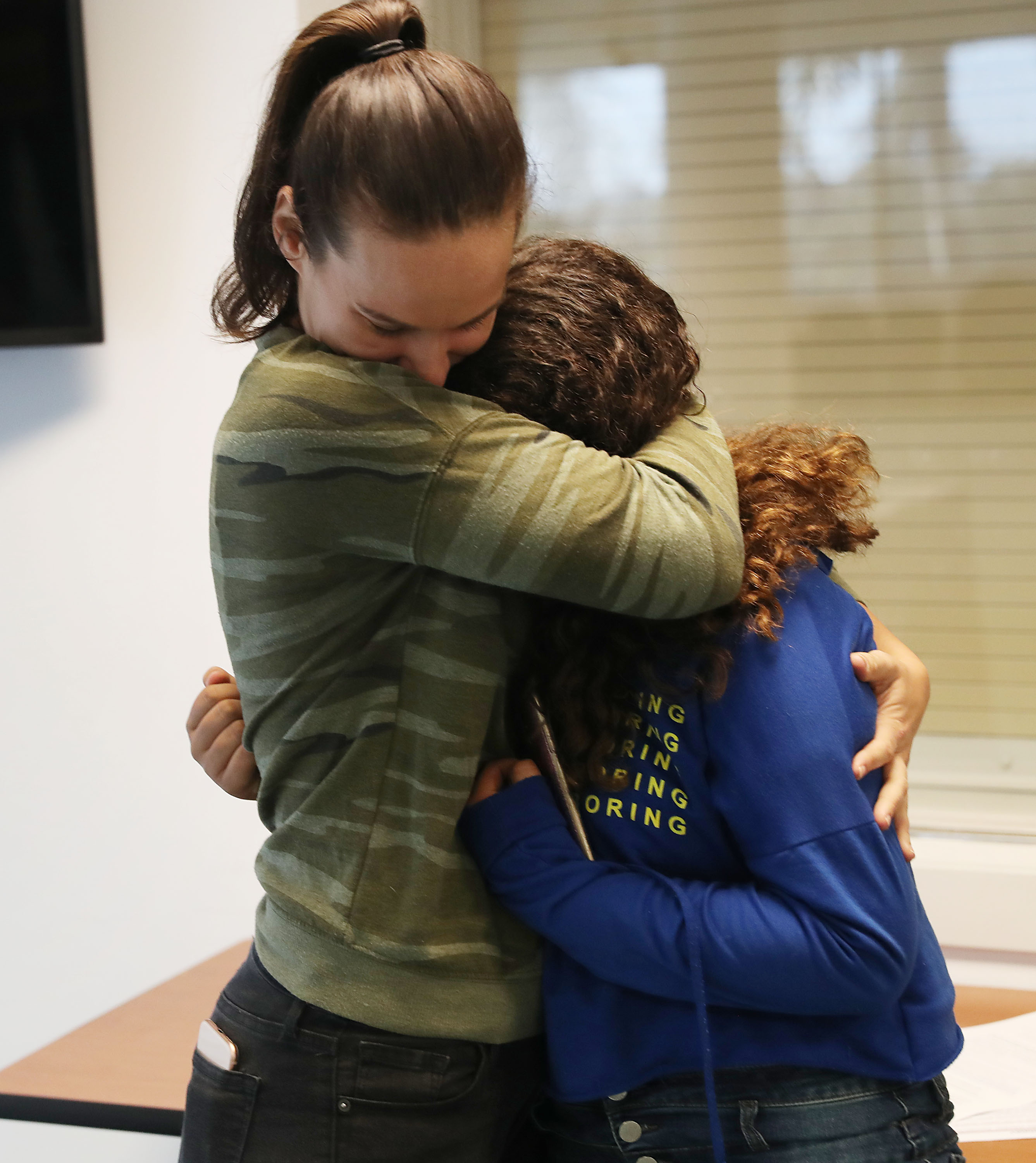 Erica Racz hugs her daughter after registering to vote at the Lee County Supervisor of Elections office. CREDIT: Joe Raedle/Getty Images