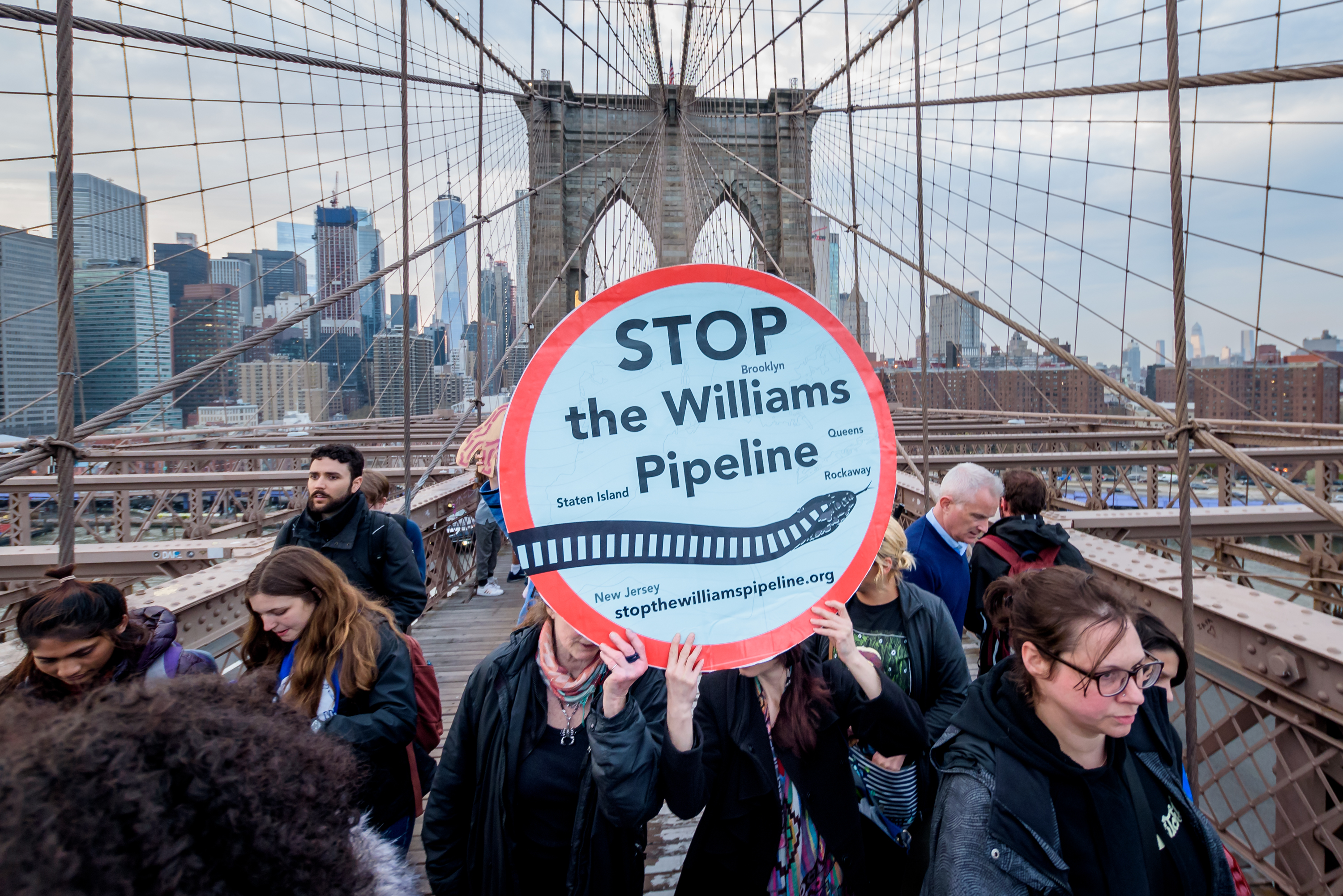 In a line that stretched upwards of a mile, over 700 New Yorkers marched across the Brooklyn Bridge on April 18, 2019 to demand Governor Andrew Cuomo to block the controversial Williams Northeast Supply Enhancement (NESE) Pipeline, which would carry fracked gas through New York Harbor. CREDIT: Erik McGregor/Pacific Press/LightRocket via Getty Images