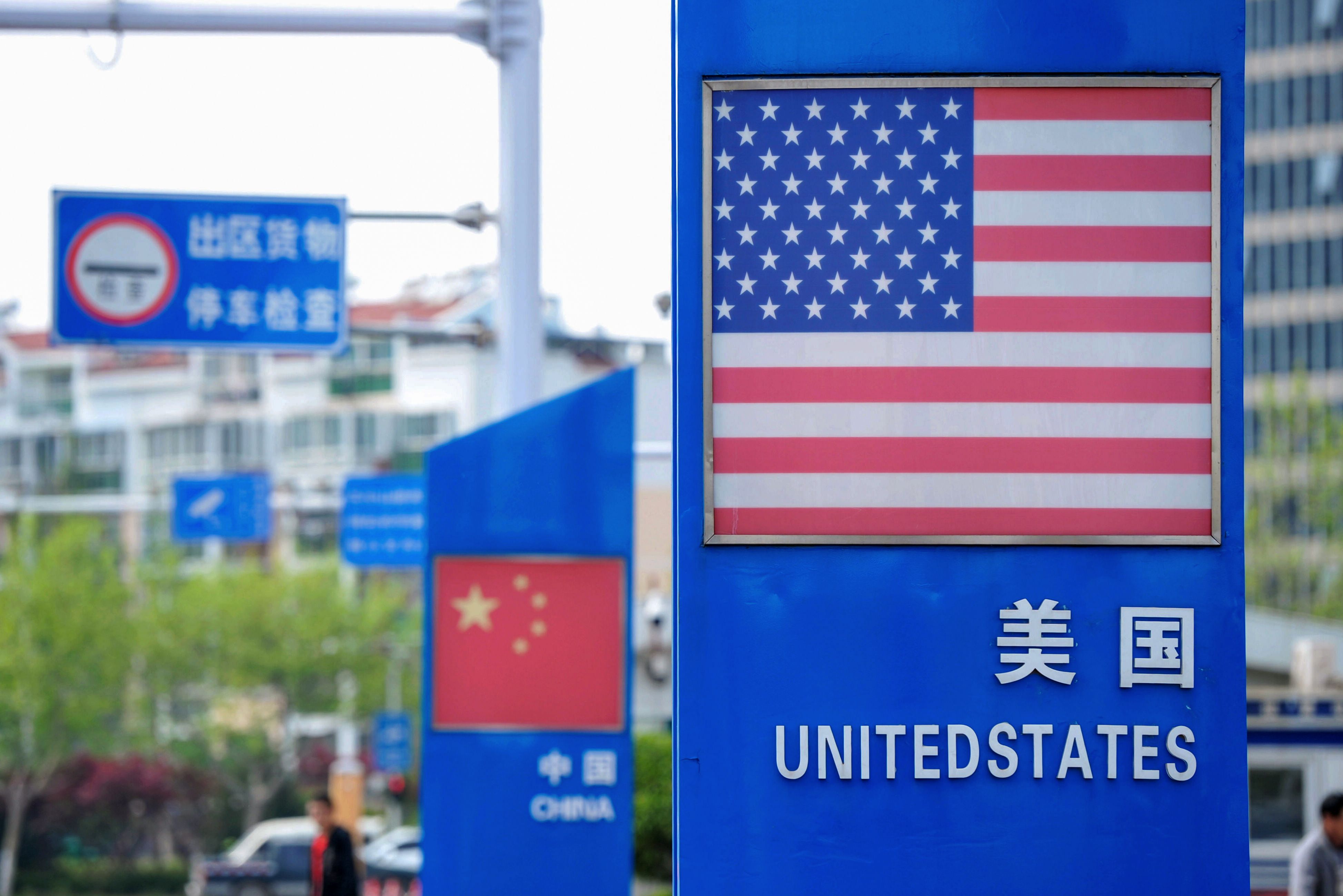 Signs with the US flag and Chinese flag are seen at the Qingdao free trade port area in Qingdao in China's eastern Shandong province on May 8, 2019. CREDIT: STR/AFP/Getty Images.