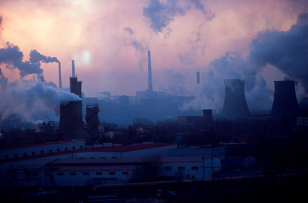 Sun sets on the Bao steel mill in Baotou, Inner Mongolia, China. Baotou, a one-industry town, is also notorious as a big polluter, mostly from the large Bao Steel factory. (Photo credit: Ryan Pyle/Corbis via Getty Images)