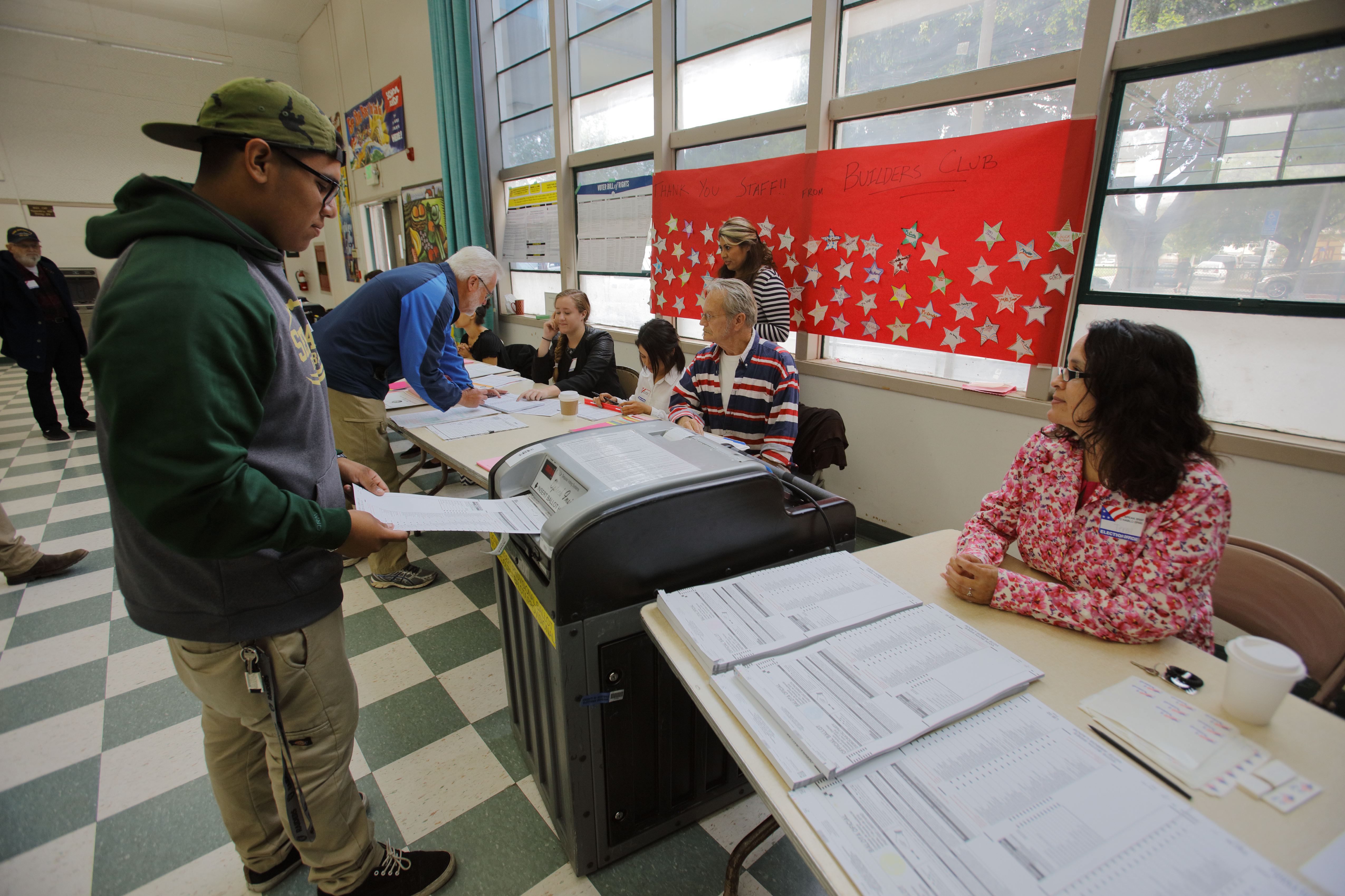A voter turns in ballot at a polling station in Ventura County, California. The Golden State's voters will play an outsized role in the 2020 Democratic presidential primary on Super Tuesday. (Photo by: Joe Sohm/Visions of America/UIG via Getty Images)