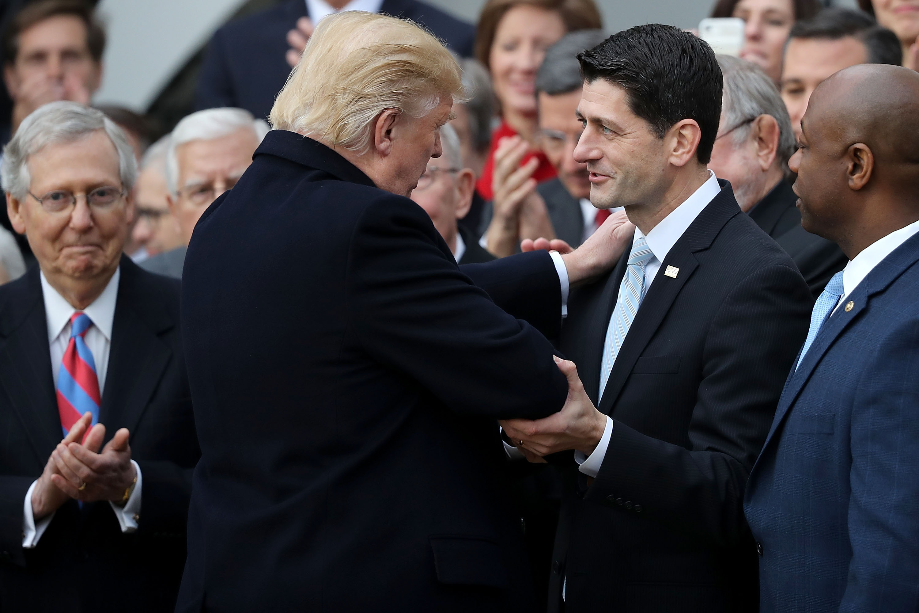 WASHINGTON, DC - DECEMBER 20: U.S. President Donald Trump congratulates Speaker of the House Paul Ryan on passing the Tax Cuts and Jobs Act with Senate Majority Leader Mitch McConnell. (Photo by Chip Somodevilla/Getty Images)