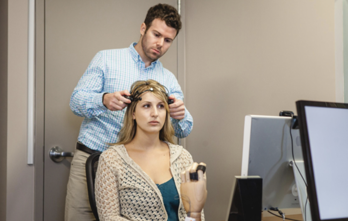 A test subject is being fitted with an electroencephalogram (EEG) headset. CREDIT: SPARK Neuro.