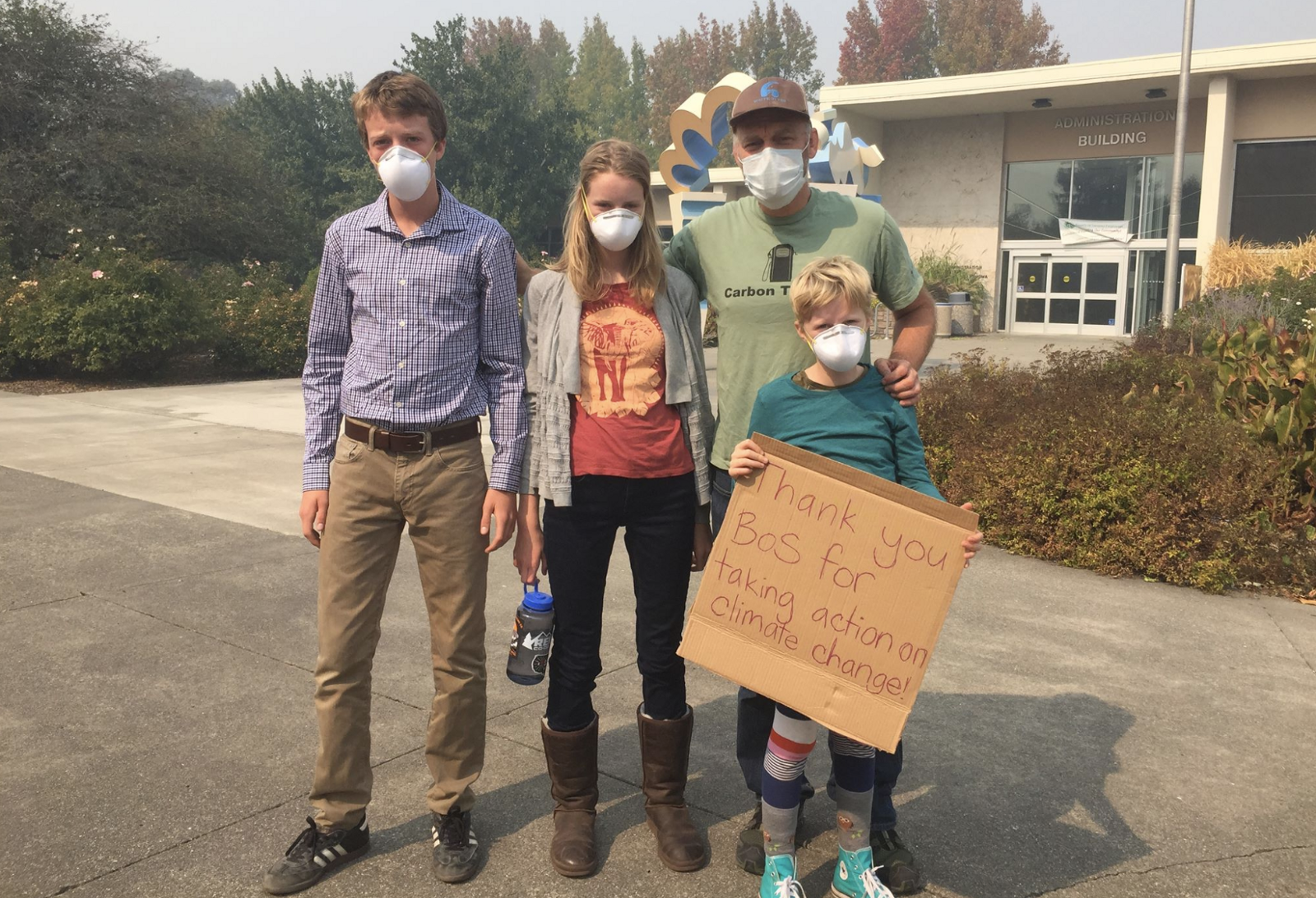 Park Guthrie (right) and his children, including Kai (left), attending a cancelled Sonoma County Board of Supervisors during the 2017 Tubbs fire. CREDIT: Schools for Climate Action