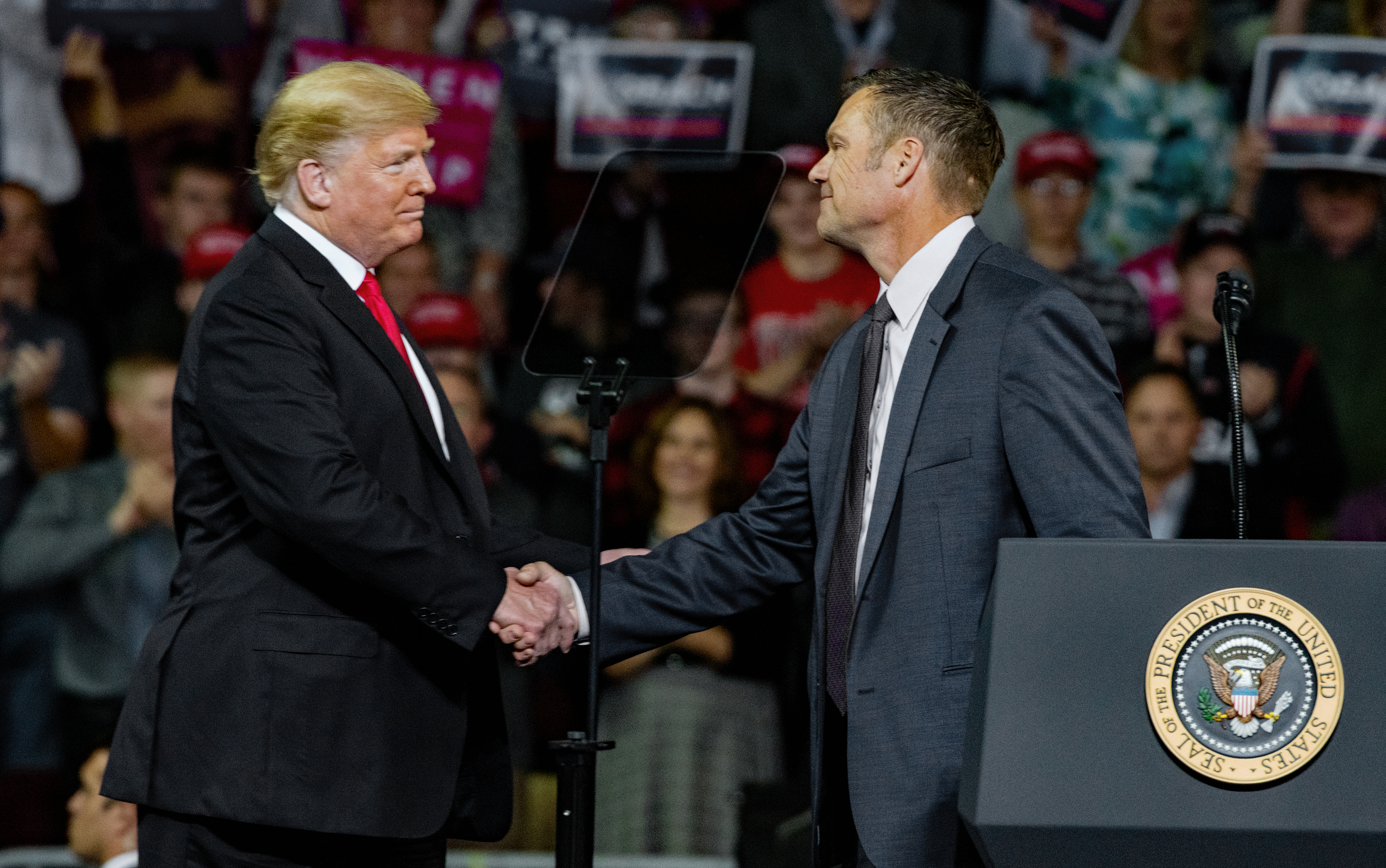 Preisdent Donald Trump and Kris Kobach at a MAGA rally held last October. (Photo CREDIT: Mark Reinstein/Corbis via Getty Images)