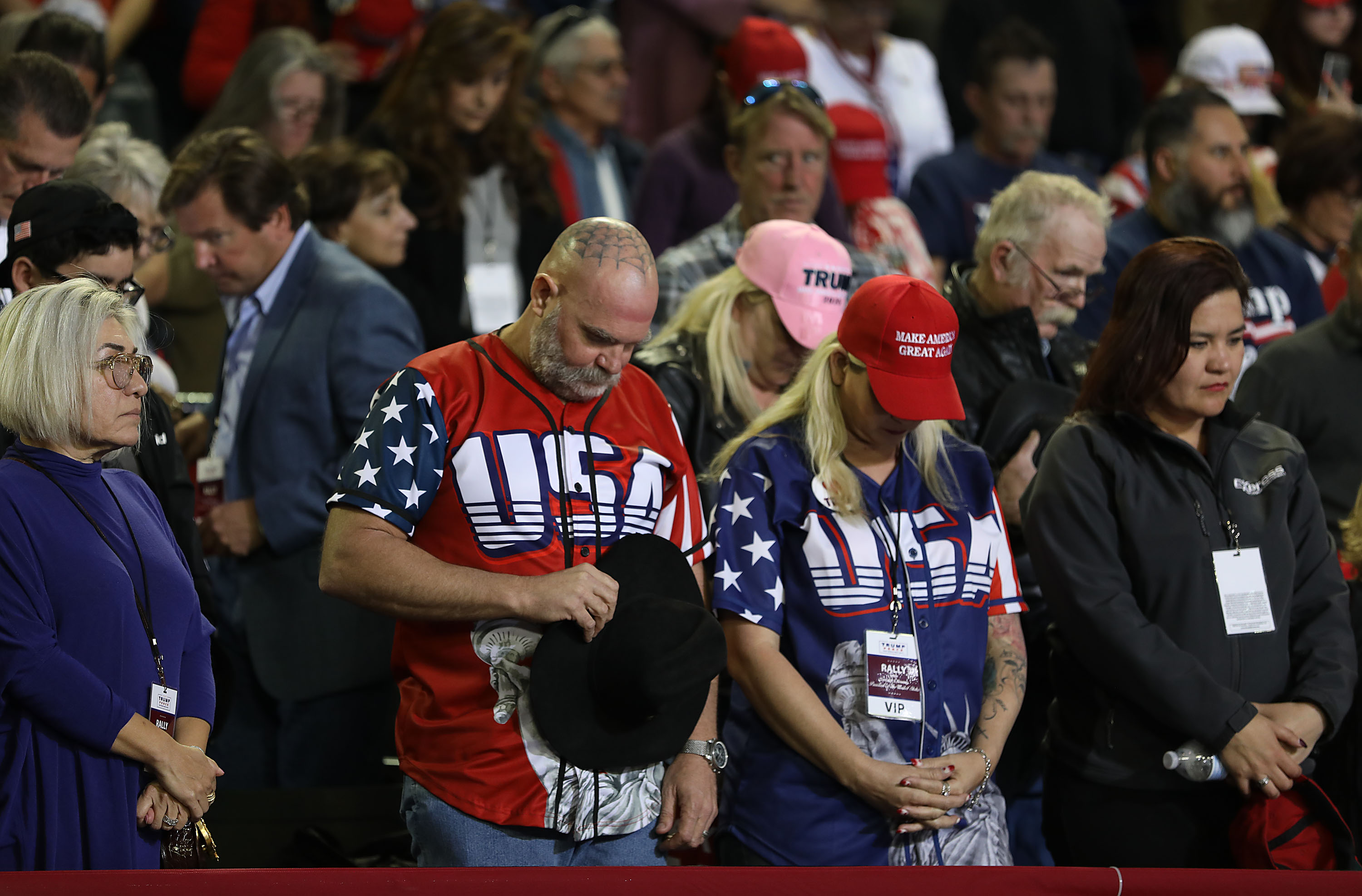 People bow their heads in prayer before the arrival of President Donald Trump at his rally on February 11, 2019 in El Paso, Texas. (Credit: Joe Raedle/Getty Images)