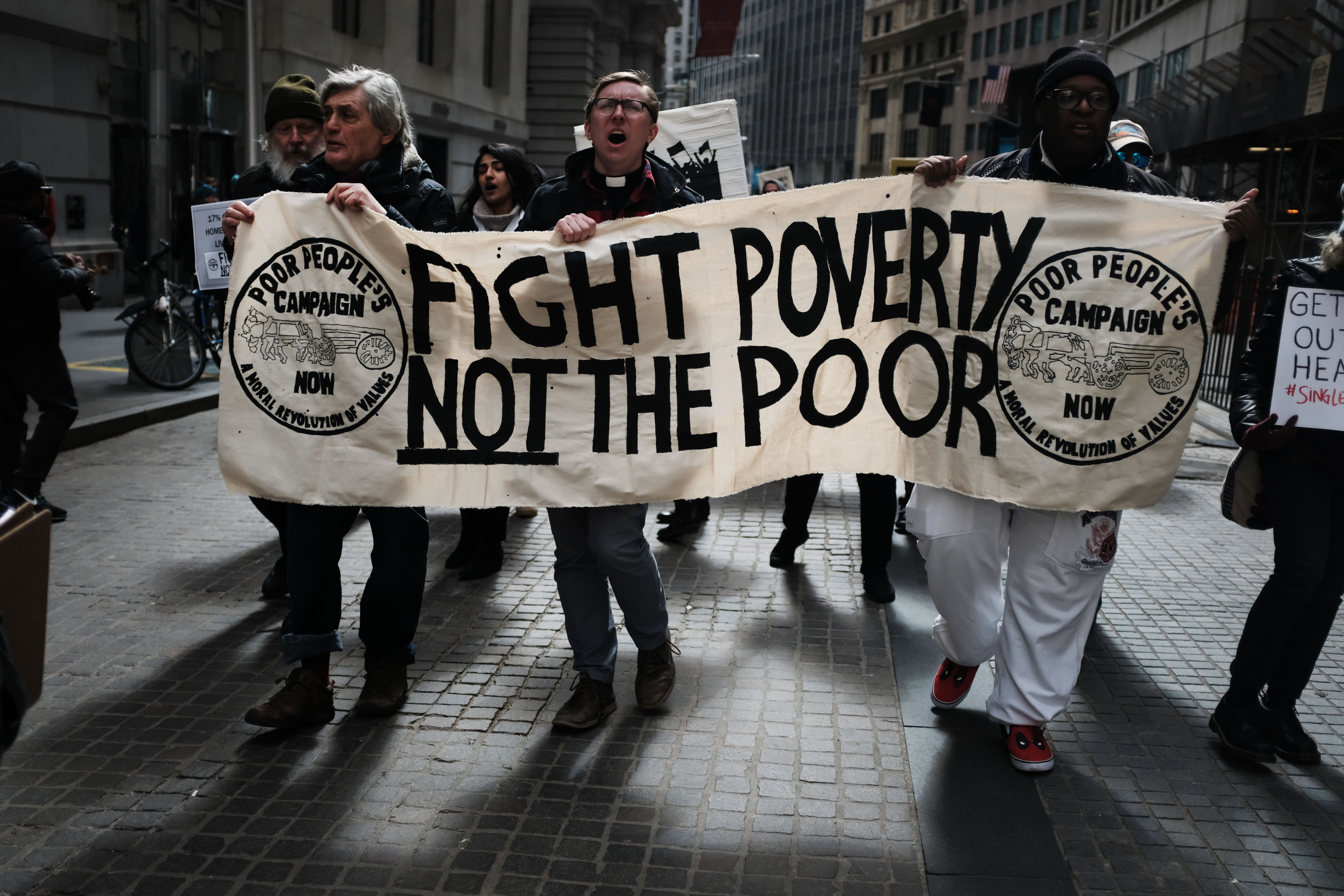 People participate in a march for the Poor People's Campaign in the Financial District on March 18, 2019 in New York City. Calling itself 'a national call for moral revival', the Poor People's Campaign is active in more than 30 states across the nation and looks to draw attention to issues of poverty, racism, housing and health care. (Photo Credit: Spencer Platt/Getty Images)