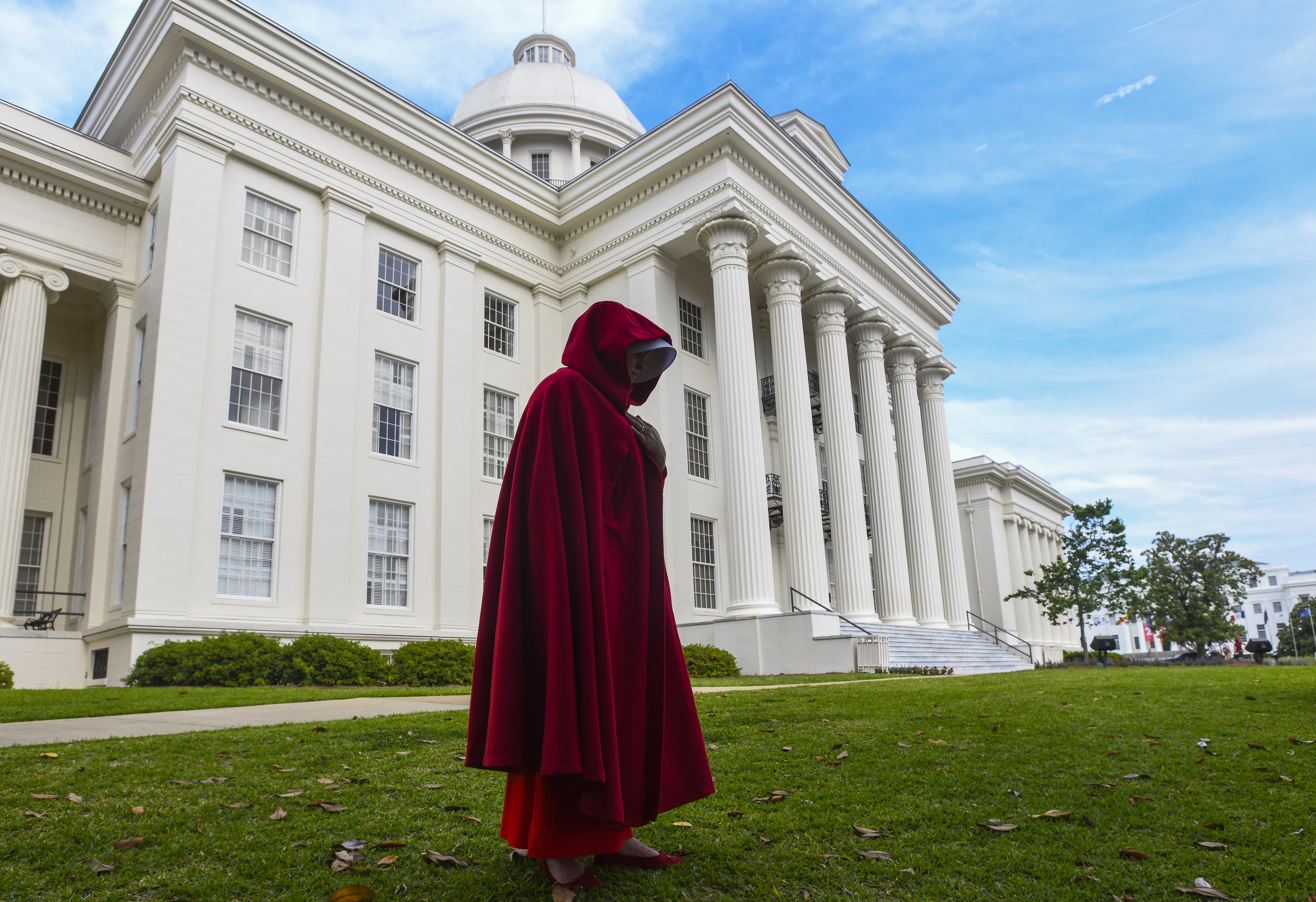 A protestor dressed as a character from the Hulu TV show "The Handmaid's Tale," based on the best-selling novel by Margaret Atwood, walks back to her car after participating in a rally against one of the nation's most restrictive bans on abortions on May 19, 2019 in Montgomery, Alabama. The law will make almost all abortion procedures illegal. (Photo by Julie Bennett/Getty Images)