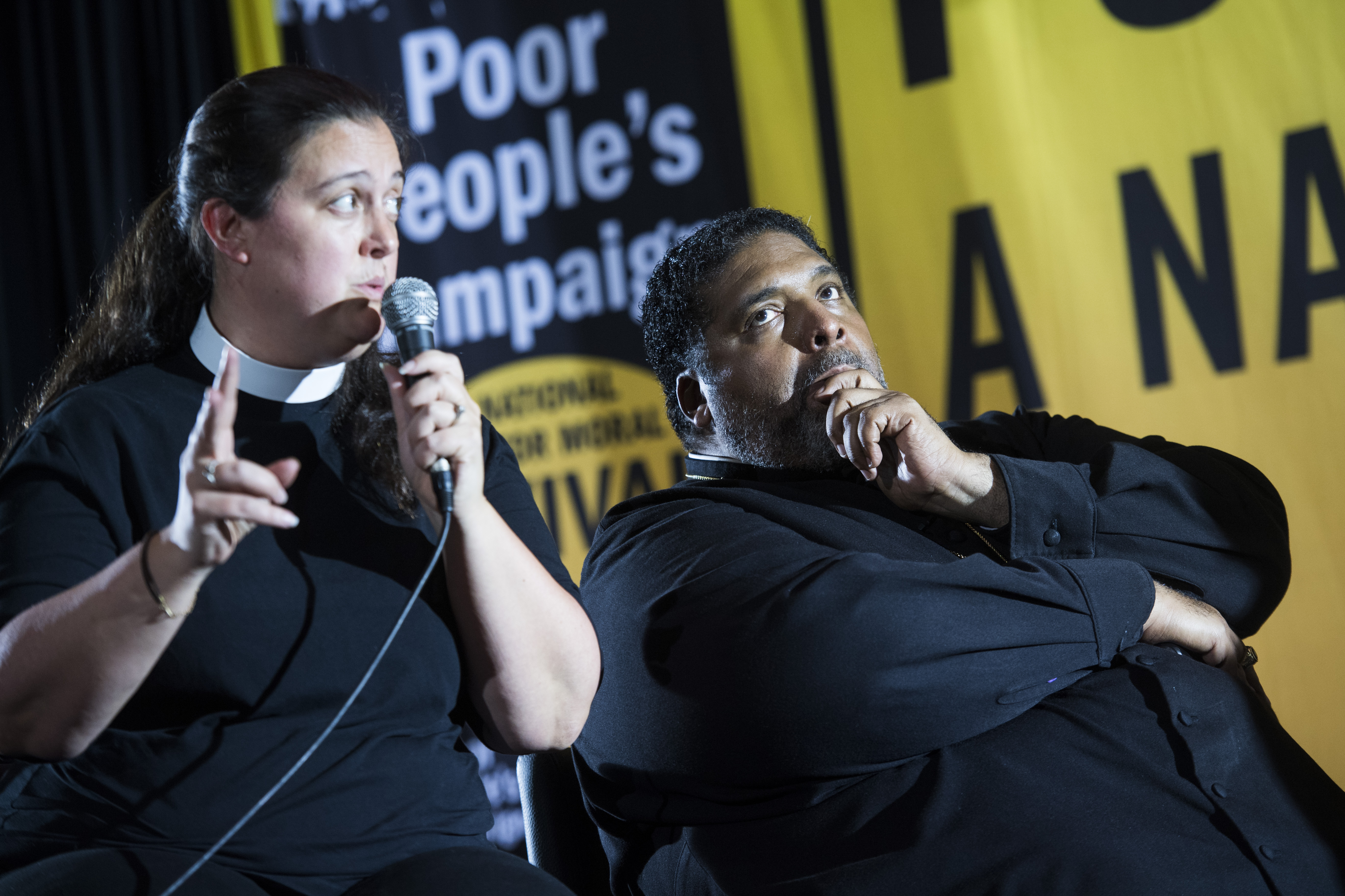Rev. Dr. Liz Theoharis and Rev. Dr. William J. Barber II, are seen on stage with Democratic candidate Joe Biden during the Poor Peoples Moral Action Congress forum for presidential candidates at Trinity Washington University on Monday, June 17, 2019. (Photo By Tom Williams/CQ Roll Call)