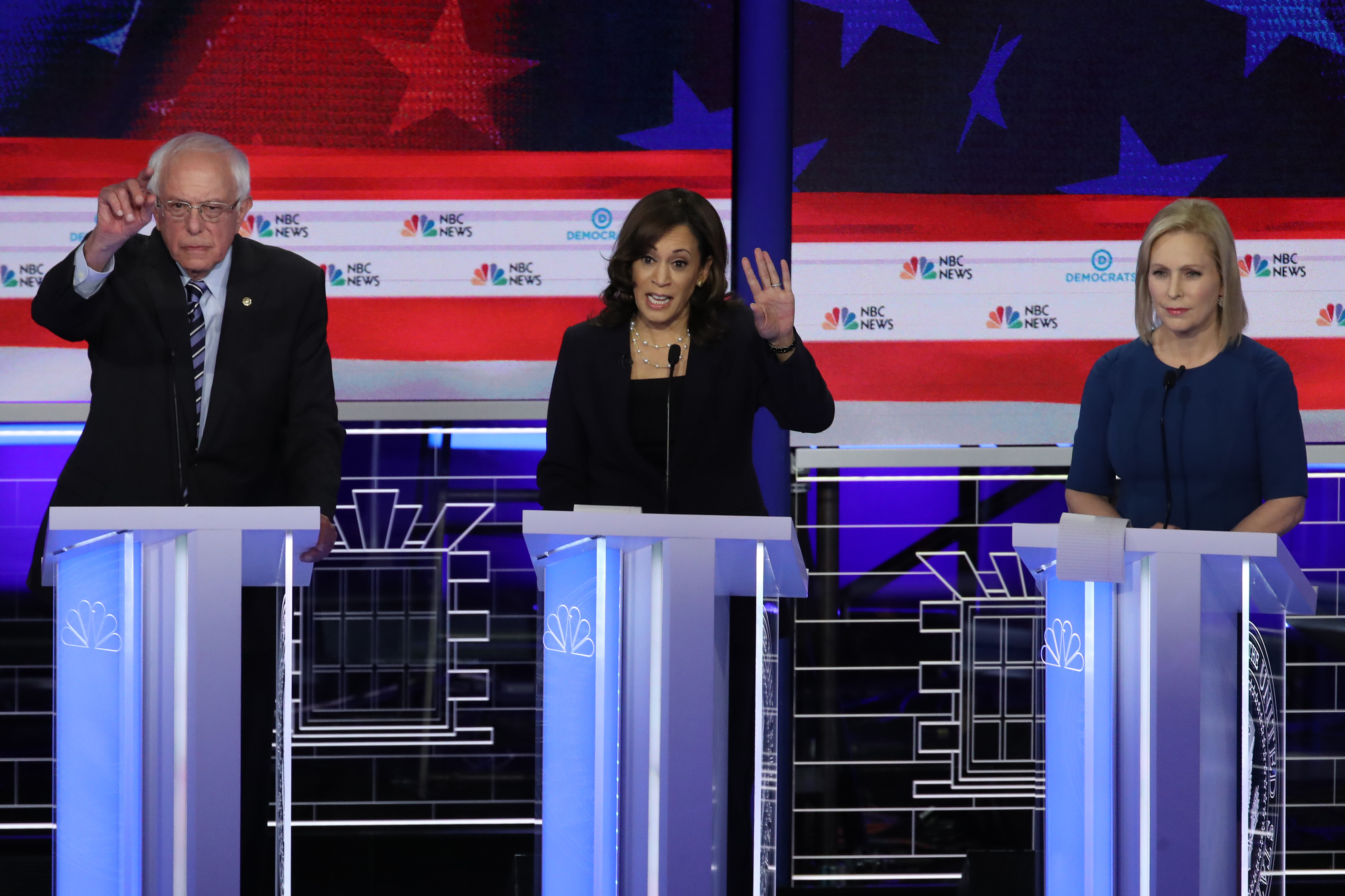 MIAMI, FLORIDA - JUNE 27: Sen. Kamala Harris (D-CA) speaks while Sen. Bernie Sanders (I-VT) and Sen. Kirsten Gillibrand (D-NY) listen during the second night of the first Democratic presidential debate on June 27, 2019 in Miami, Florida. A field of 20 Democratic presidential candidates was split into two groups of 10 for the first debate of the 2020 election, taking place over two nights at Knight Concert Hall of the Adrienne Arsht Center for the Performing Arts of Miami-Dade County, hosted by NBC News, MSNBC, and Telemundo. (Photo by Drew Angerer/Getty Images)