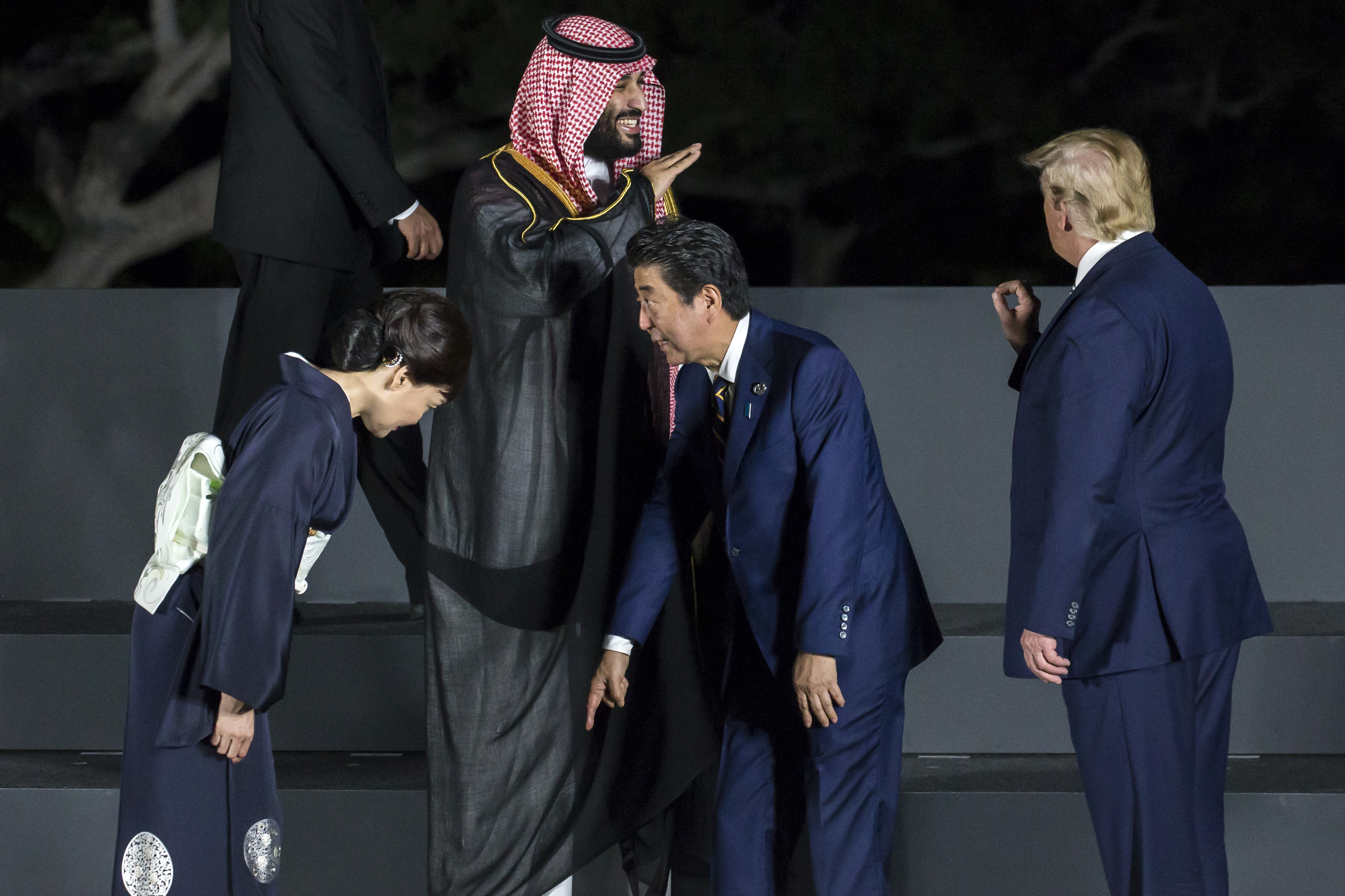 Japan' Prime Minister Shinzo Abe checks his position with his wife Akie Abe as Saudi Arabia's Crown Prince Mohammed bin Salman gestures to President Donald Trump during a photo session in front of Osaka Castle at the G-20 summit on June 28, 2019 in Osaka, Japan. CREDUT: Tomohiro Ohsumi/Getty Images.