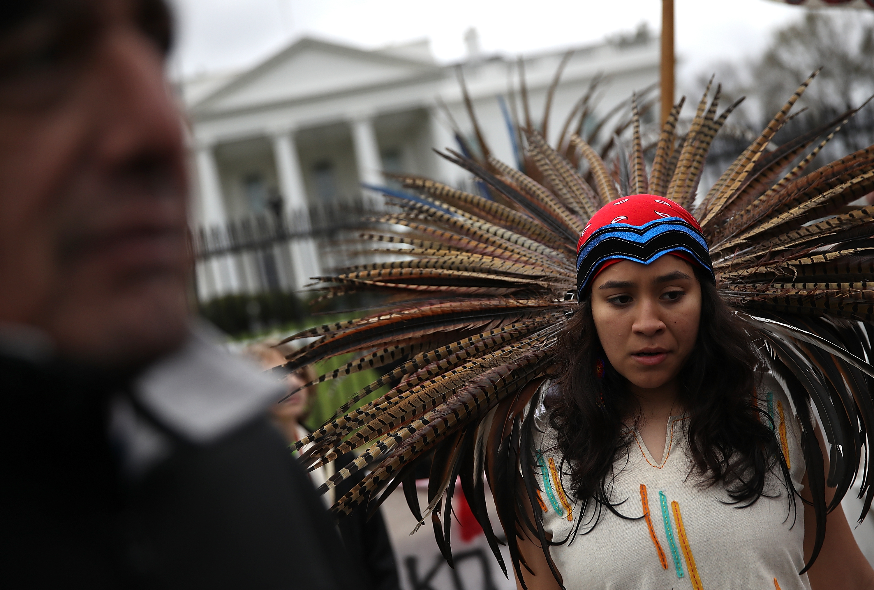 A Native American stands in front of the White House during a demonstration against the Dakota Access Pipeline on March 10, 2017 in Washington, DC. CREDIT: Justin Sullivan/Getty Images