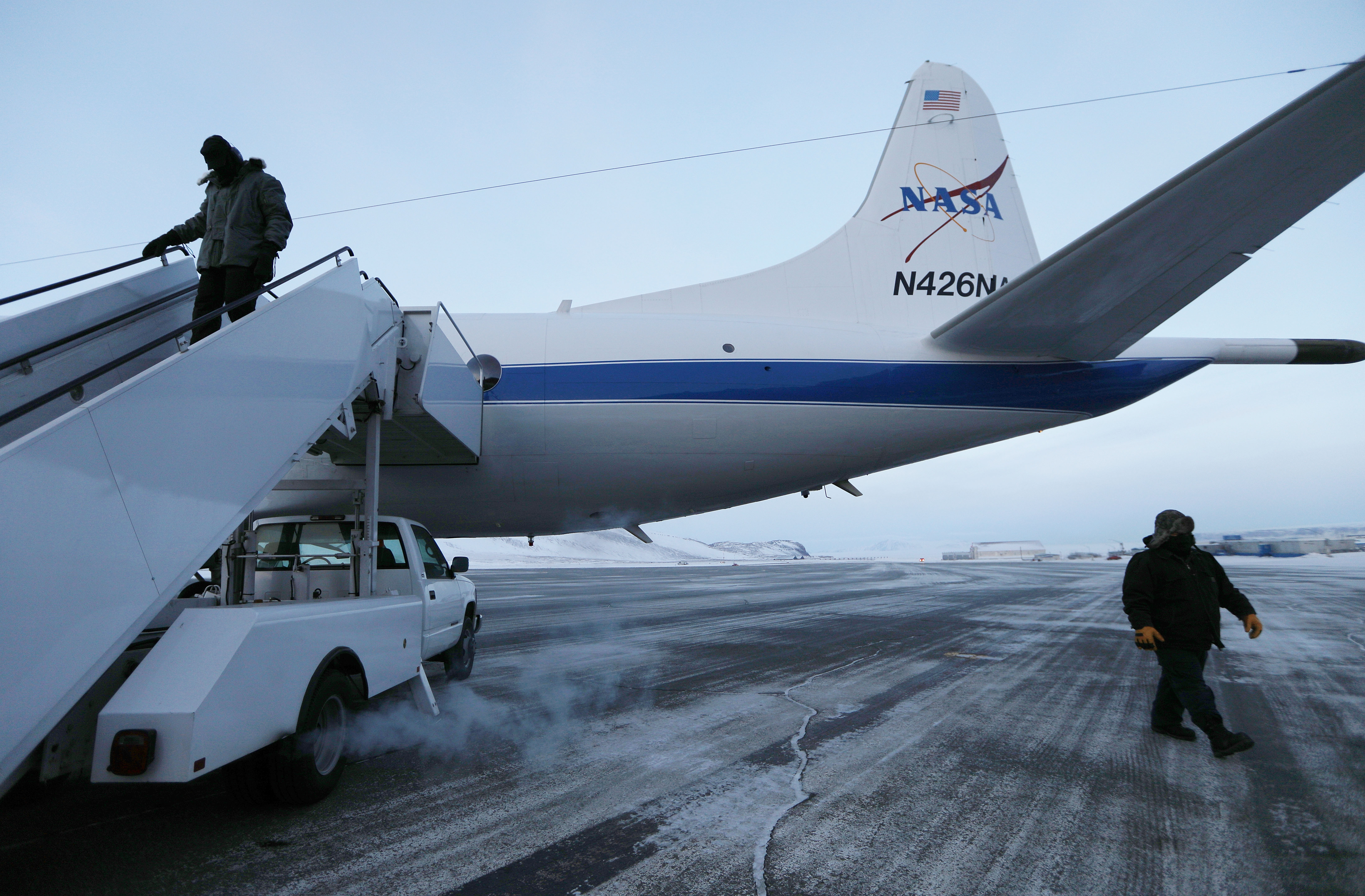Crew members work prior to NASA's Operation IceBridge research aircraft takeoff from Thule Air Base on March 27, 2017 in Pituffik, Greenland. CREDIT: Mario Tama/Getty Images