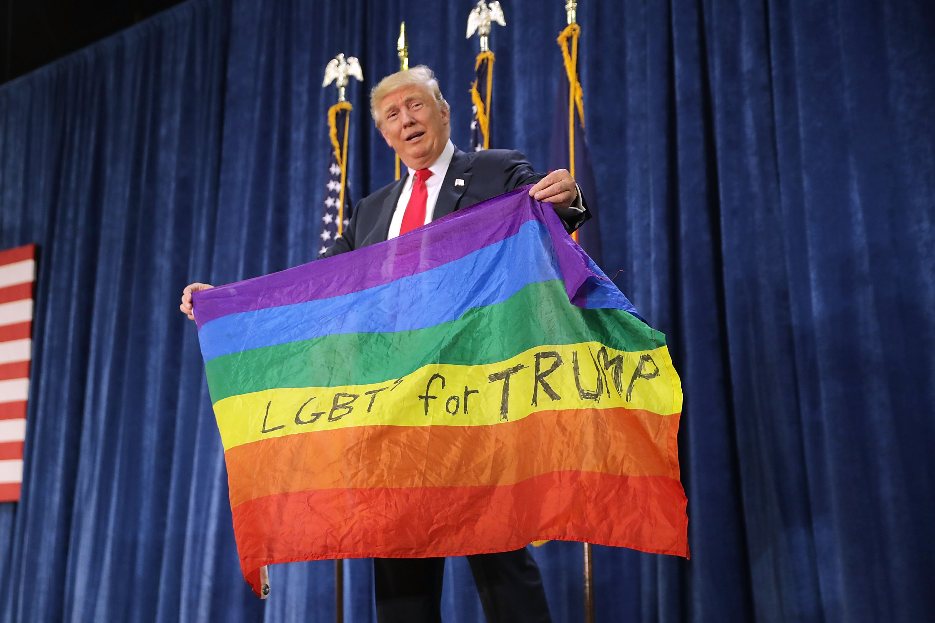 GREELEY, CO - OCTOBER 30: Republican presidential nominee Donald Trump holds an LGBT rainbow flag given to him by supporter Max Nowak during a campaign rally at the Bank of Colorado Arena on the campus of University of Northern Colorado October 30, 2016 in Greeley, Colorado. With less than nine days until Americans go to the polls, Trump is campaigning in Nevada, New Mexico and Colorado. (Photo by Chip Somodevilla/Getty Images)