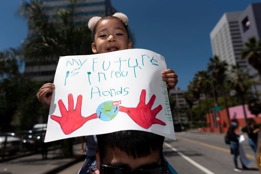 A child holds a sign that says 'My Future is in Your Hands' during a climate change demonstration in California.
(Photo credit: Ronen Tivony/SOPA Images/LightRocket via Getty Images)